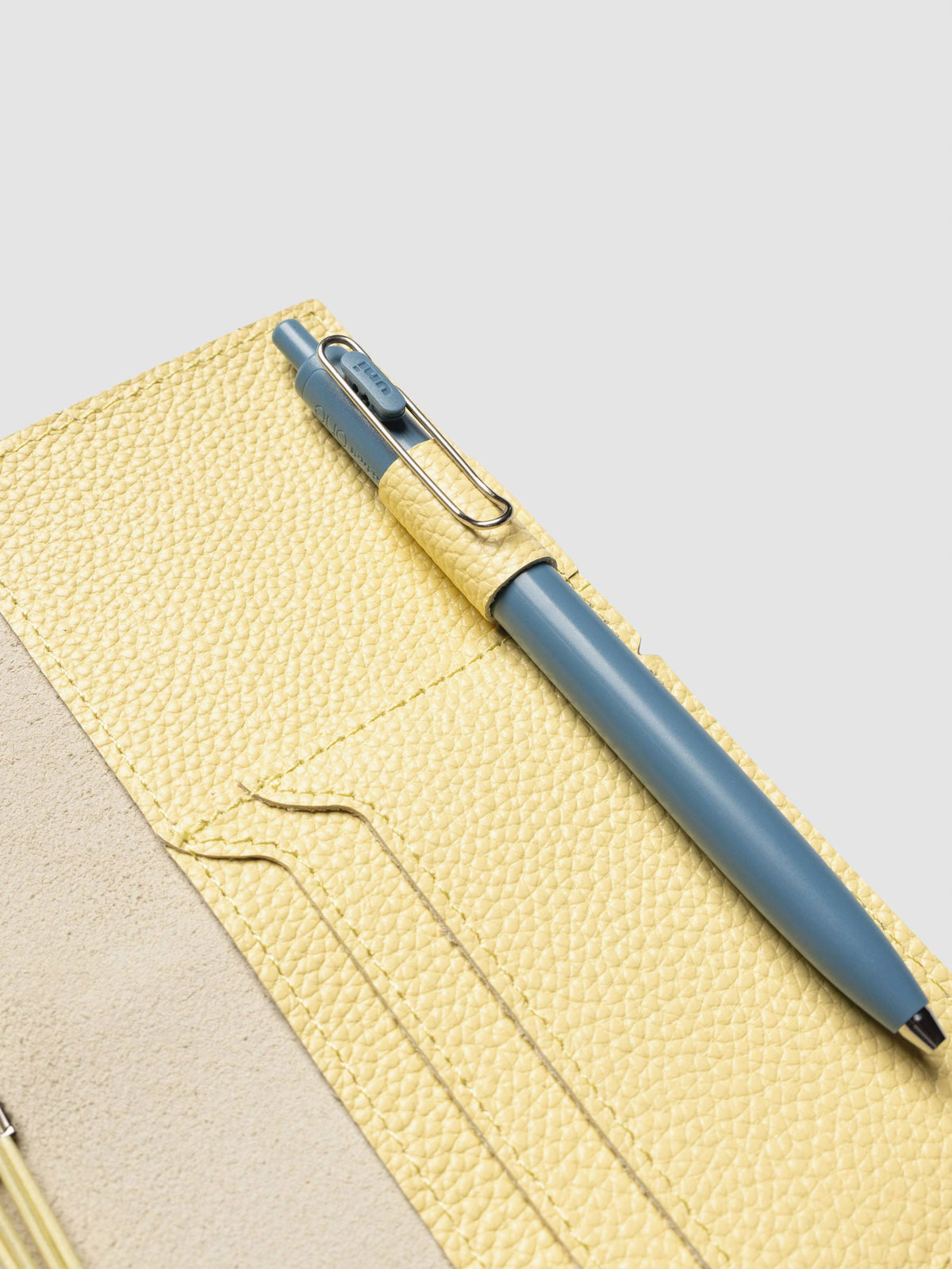Butter yellow leather travel notebook cover in size Pocket Plus shown with travel notebooks inside.