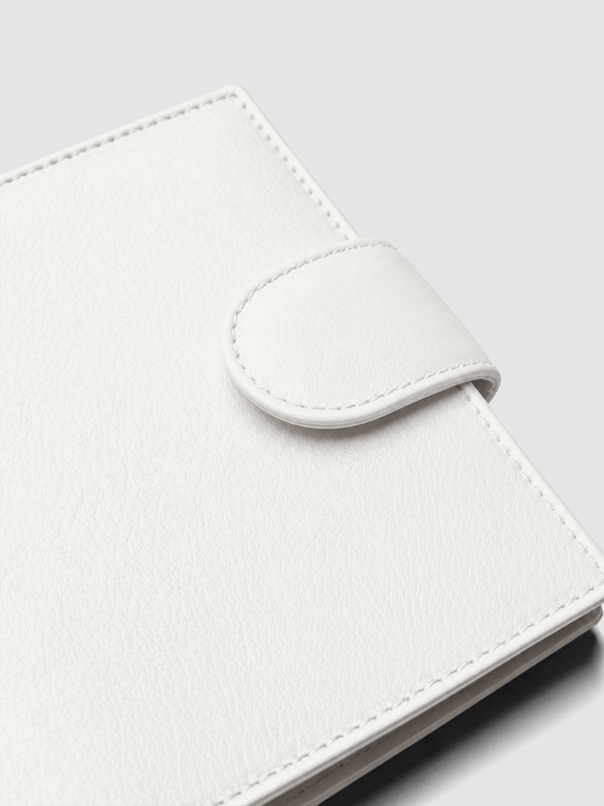 Heirloom Ring Cover Genuine Leather Pocket 6-Ring Punch in off-white, closed planner detail of closure band