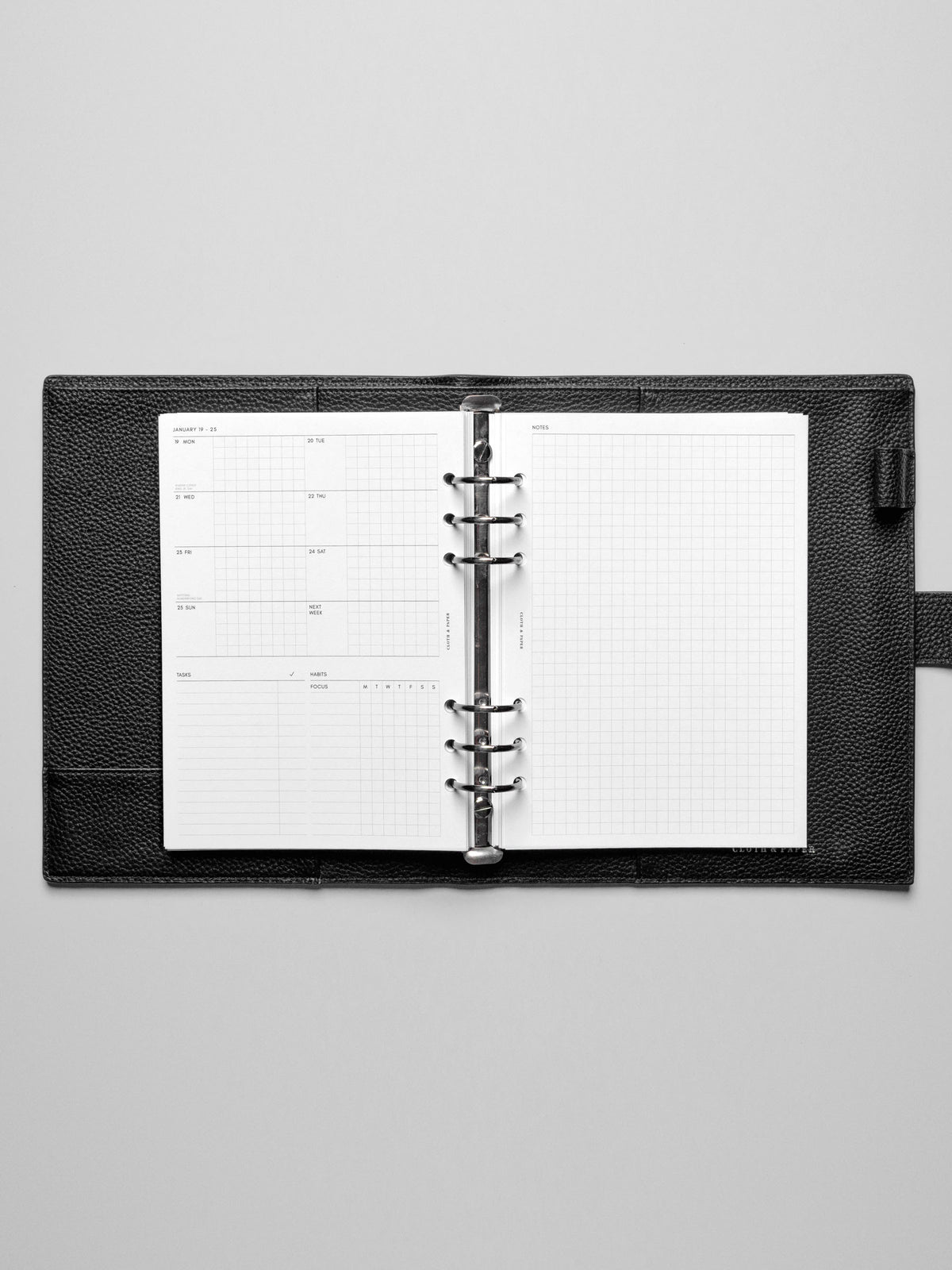 Image shows the Monday Start 2026 Dated Weekly Admin Planner Insert in a black leather ring-bound planner.