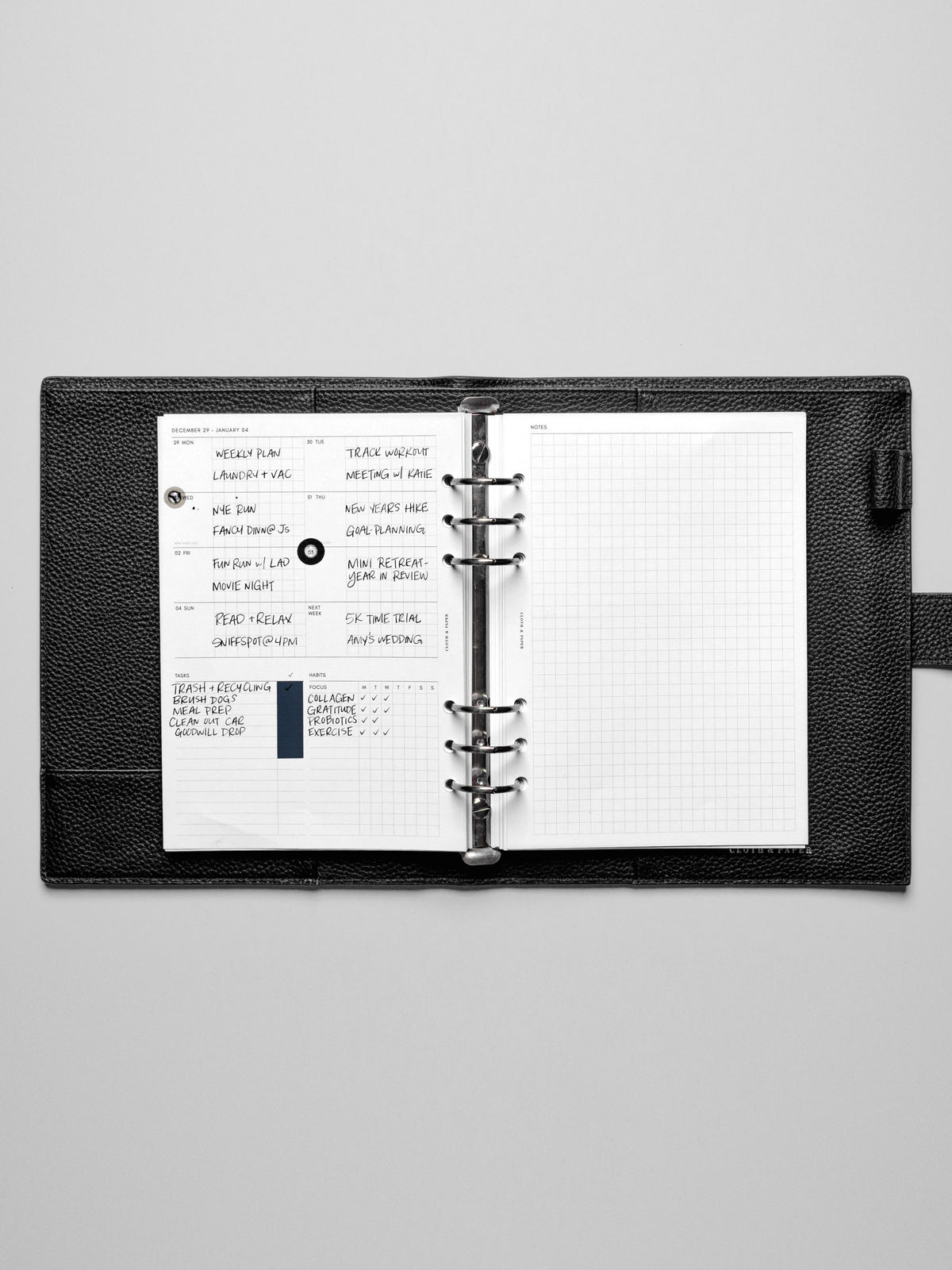 Image shows the Monday Start 2026 Dated Weekly Admin Planner Insert in a black leather ring-bound planner.