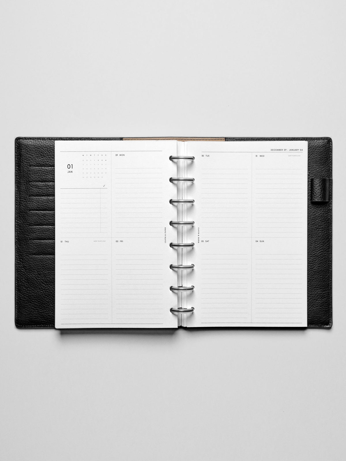 Image shows a black leather folio with the Monday Start 2026 Dated Vertical Weekly Planner Inserts used in a Half Letter disc-bound planner.