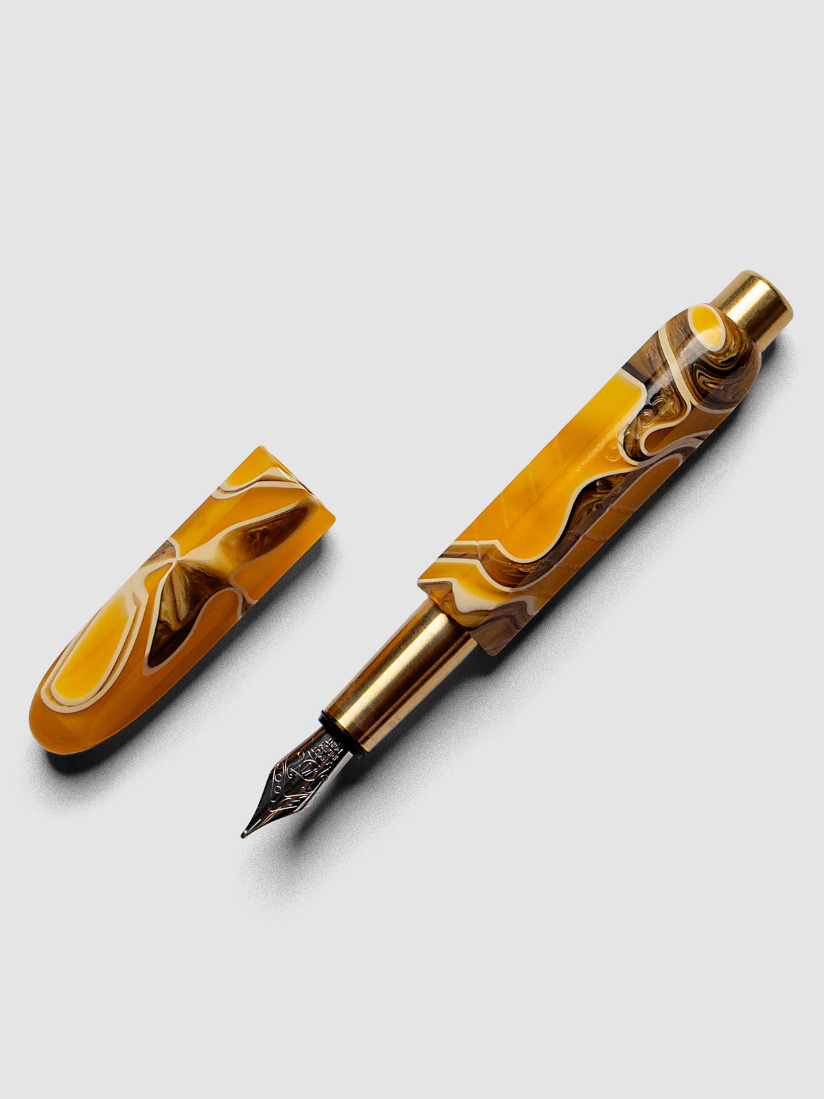 Kolo Tino Fountain Pen in the color Dune, a variegated yellow, brown, and beige barrel with brass accents and a silver medium nib shown with cap off.
