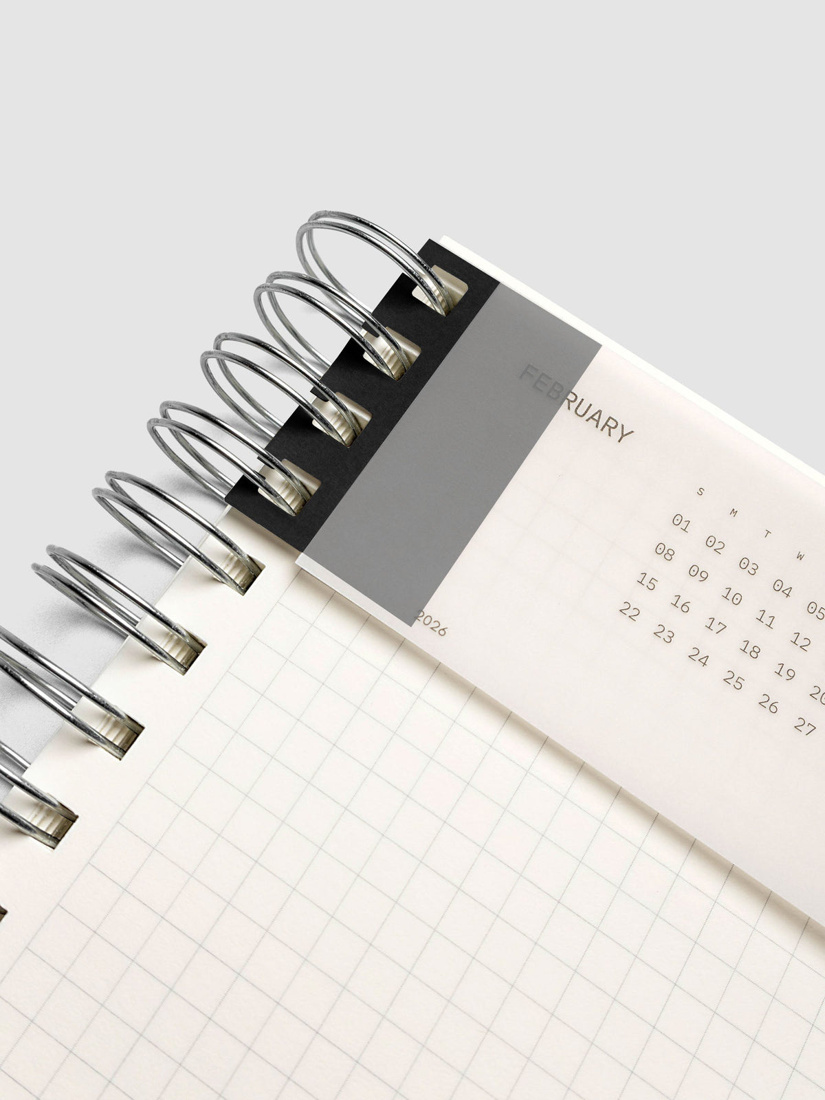 System Punch Stickers in Avant Garde, holding a page in a spiral notebook