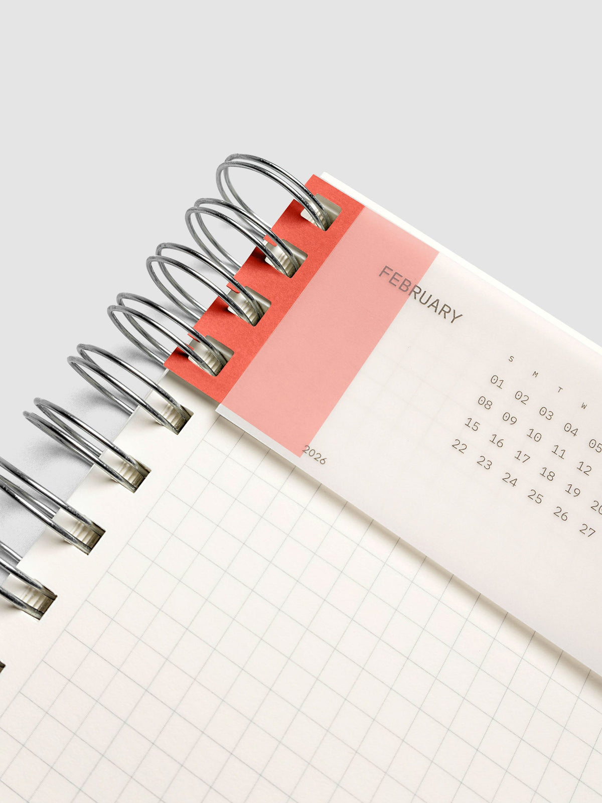 System Punch Stickers in Pimento, holding a page in a spiral notebook