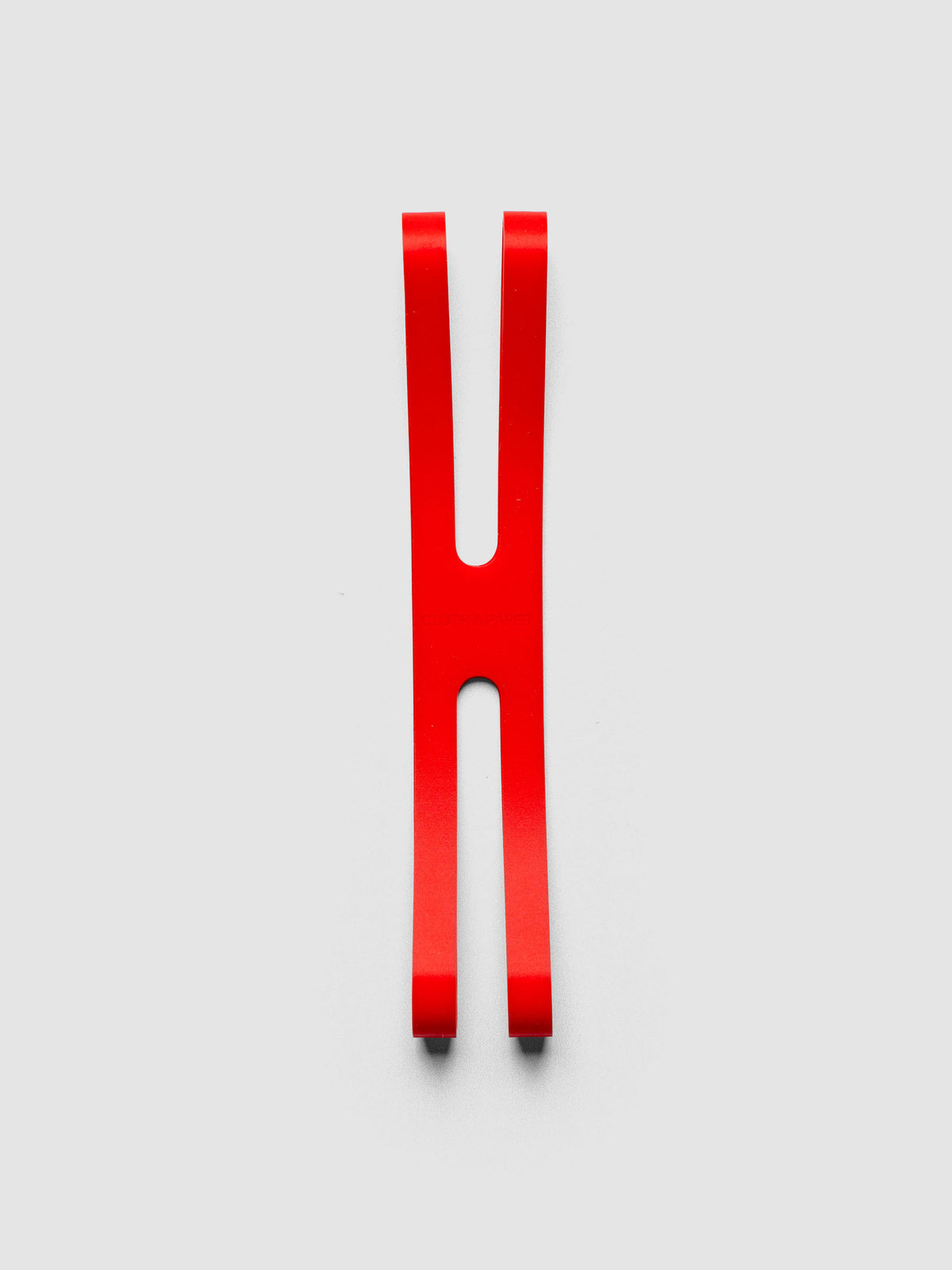 Red planner closure band on a neutral background.
