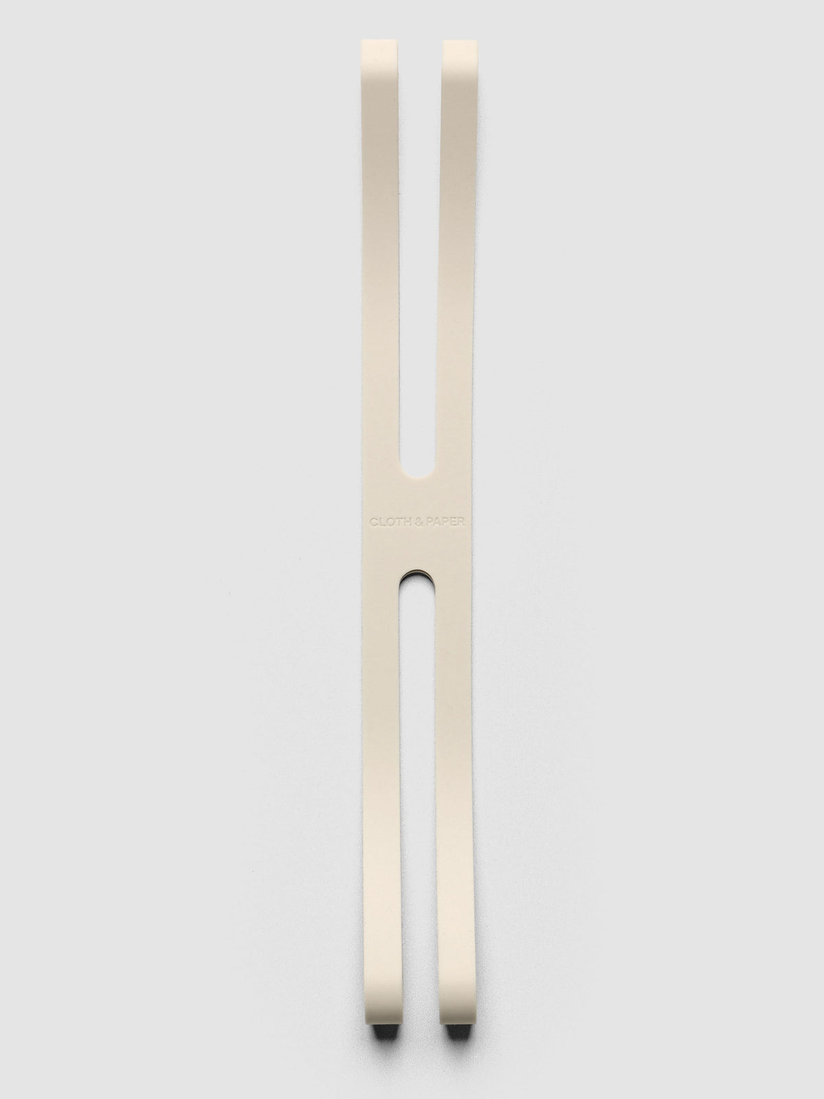Large beige planner closure band on a neutral background.