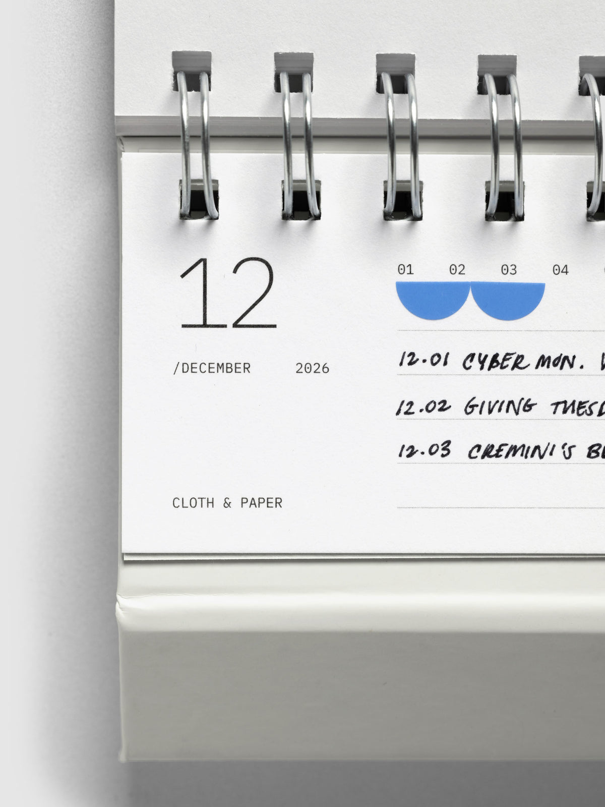 Close up of 2026 Spiral Desk Calendar shown folded and flat, displaying a calendar page.
