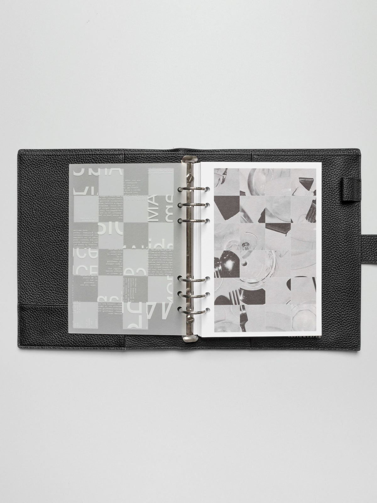 An A5 planner open to the third dashboard of the Ambiance Planner Dashboard trio, featuring an abstract grid with typography elements.