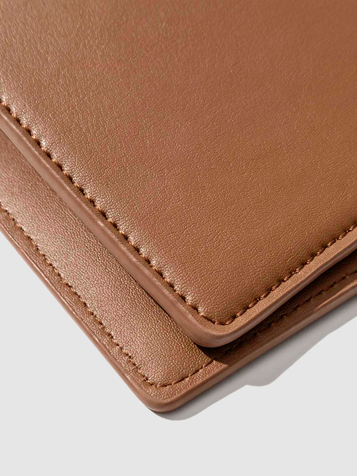 Closeup of clay brown folio's smooth vegan leather.