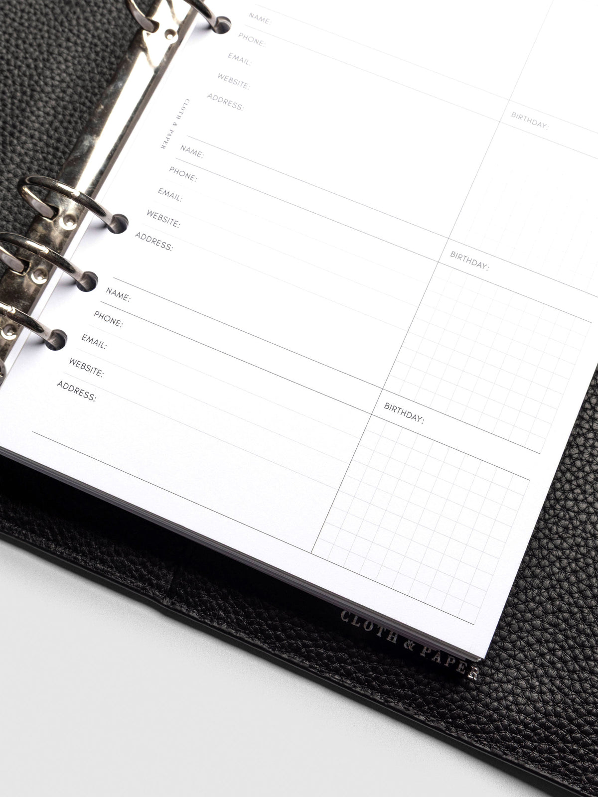 Refreshed Contact List Planner Inserts styled inside a black leather agenda.