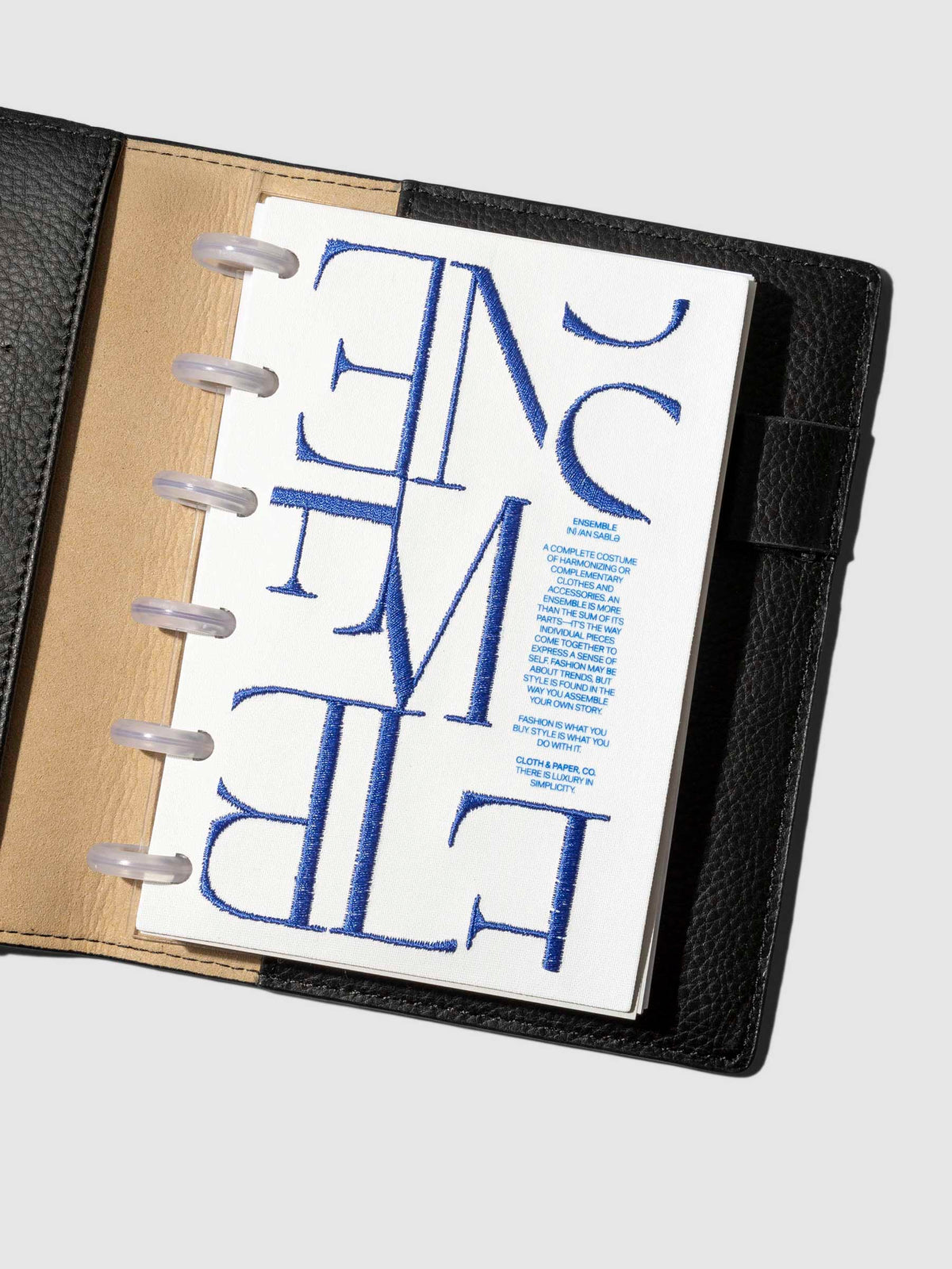 Dashboard displayed inside a leather agenda on a neutral background. Size shown is CP Petite.