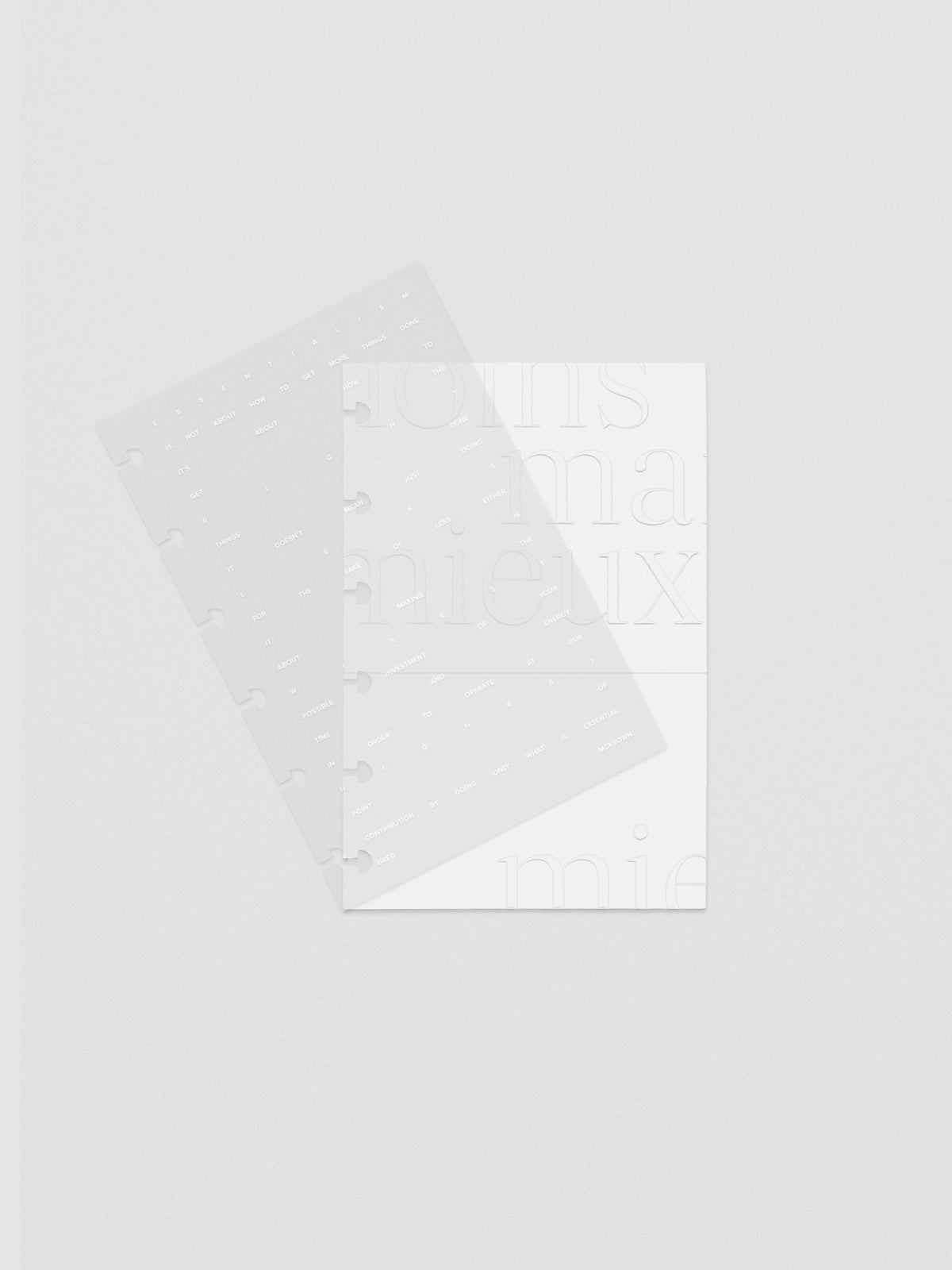 Essentialism Dashboard Duo reading "moins mai mieux" in size CP Petite; shown with layers offset.