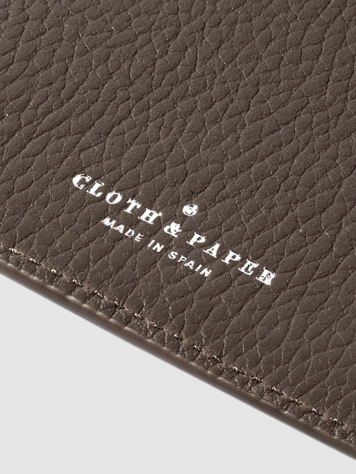 Closeup of Leon folio's foil-stamped Cloth and Paper Made in Spain logo.