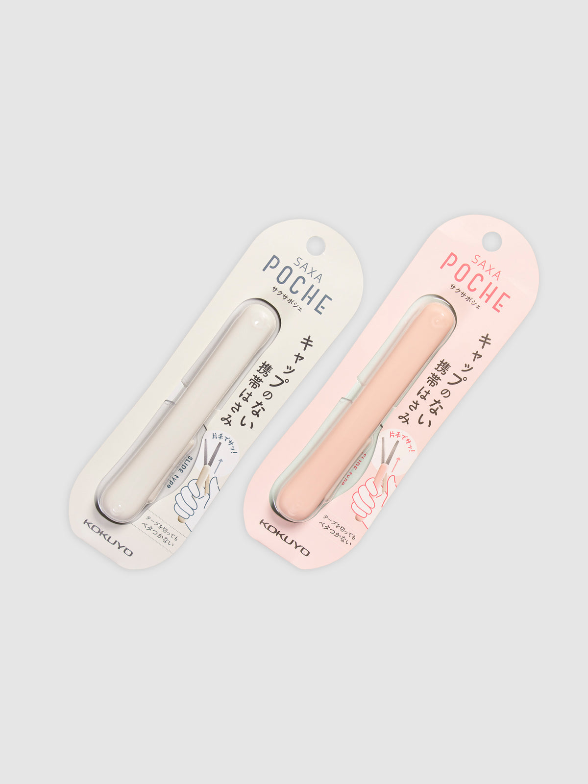 Kokuyo Saxa Poche Compact Scissors in White and Peach arranged parallel to each other against a neutral background. Both scissors are turned slightly to the right.