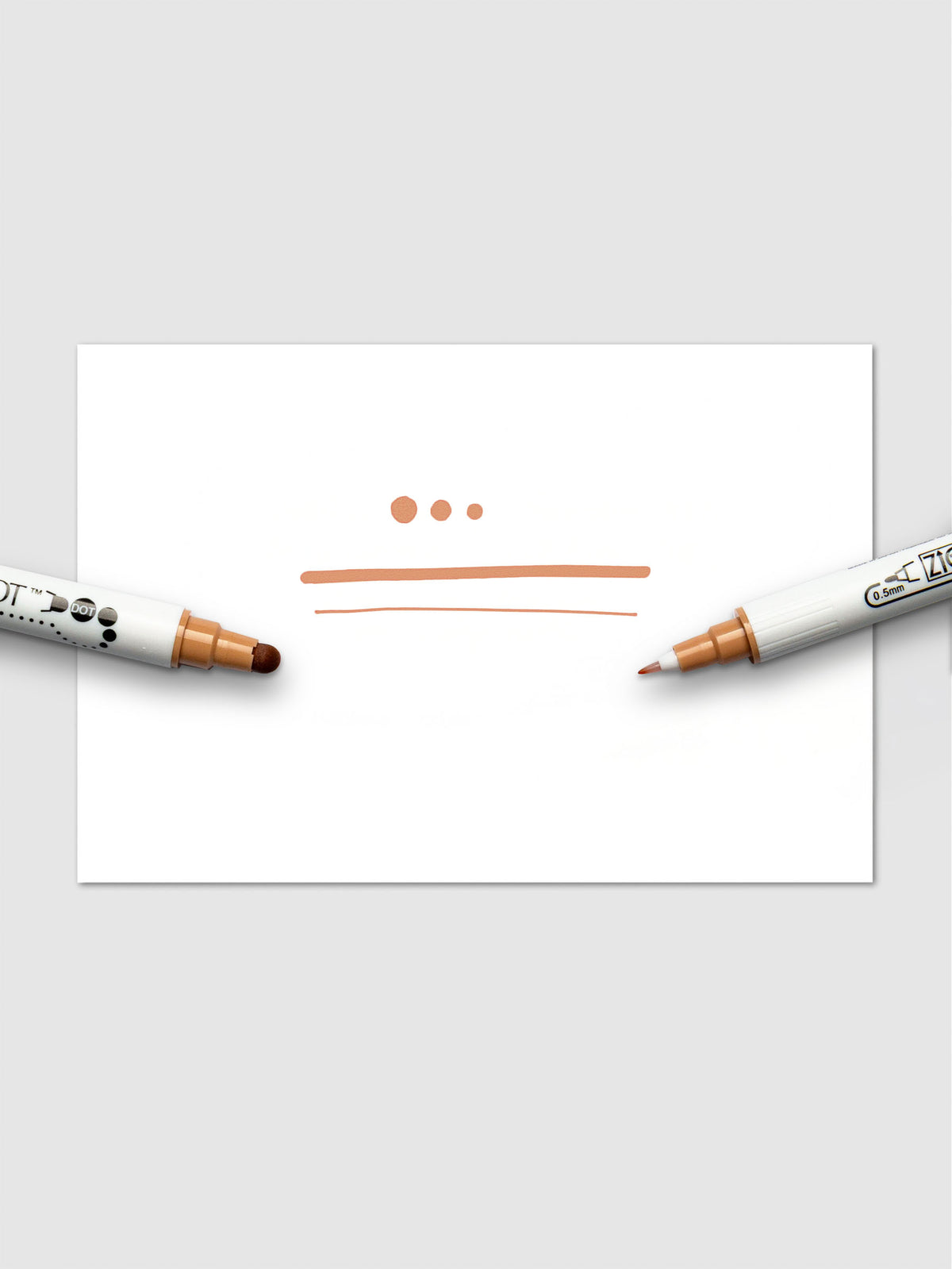 Demonstration of the Fawn marker's ink with dots and lines on white paper, highlighting the pressure-sensitive versatility of the dual tips.