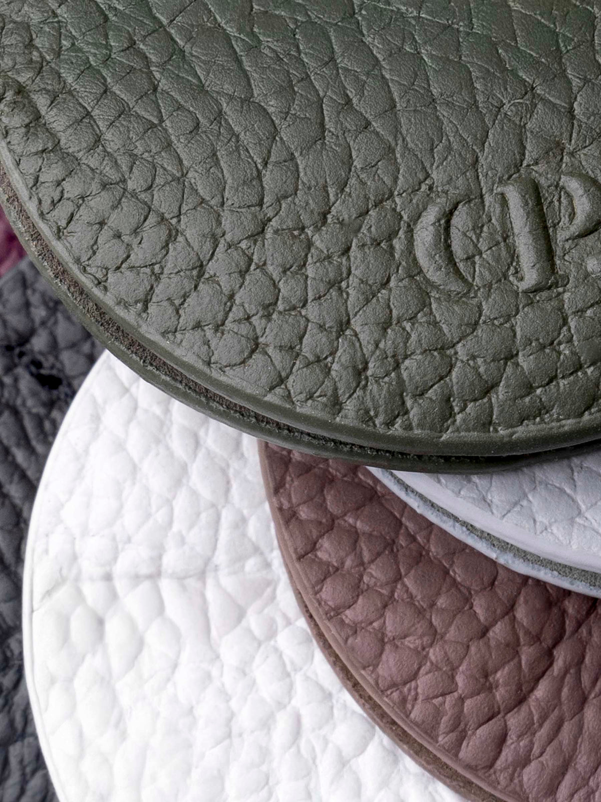 Closeup of six clips showcasing the texture of their leather construction.
