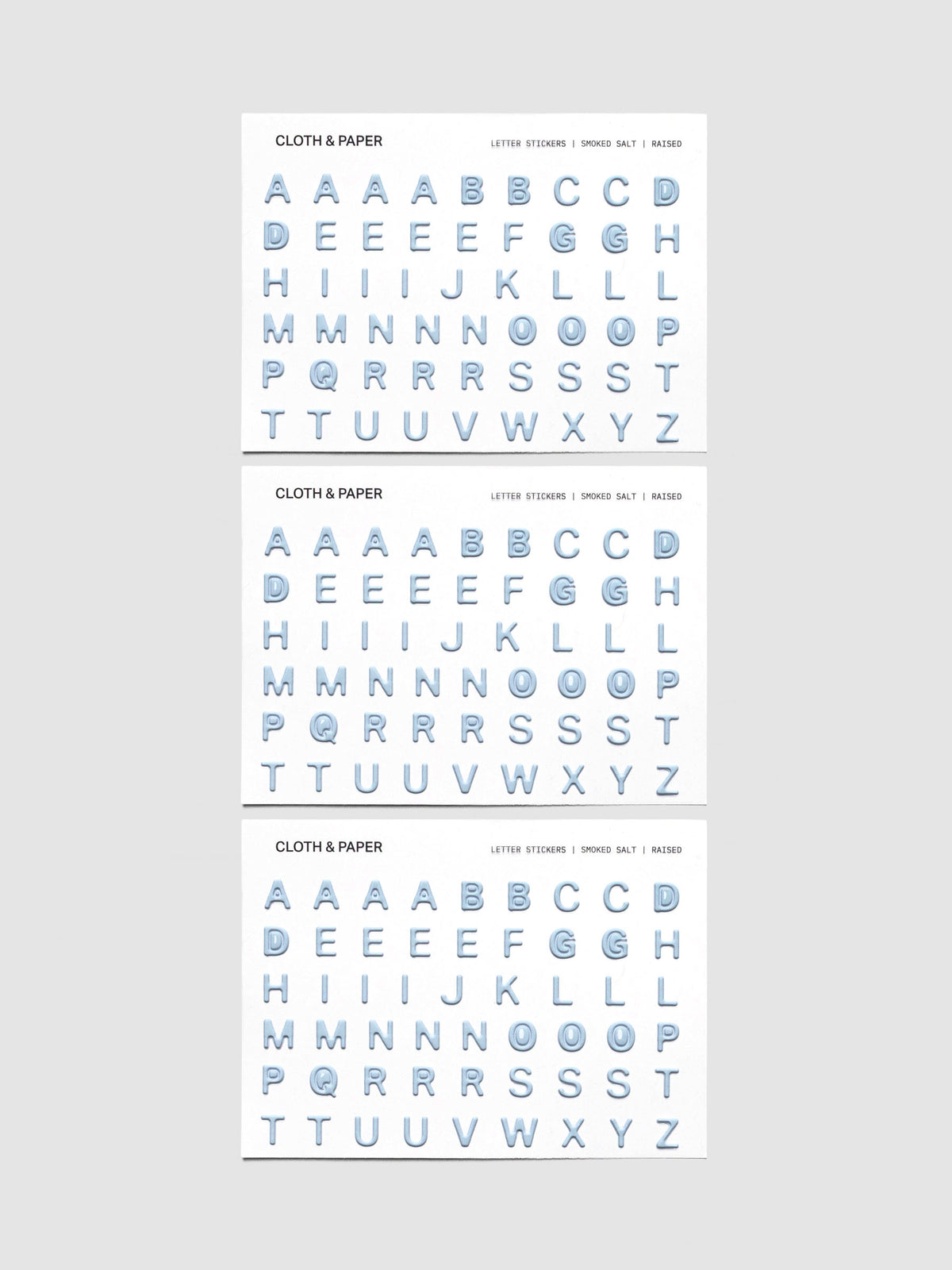 Three sheets of blue grey raised letter stickers.