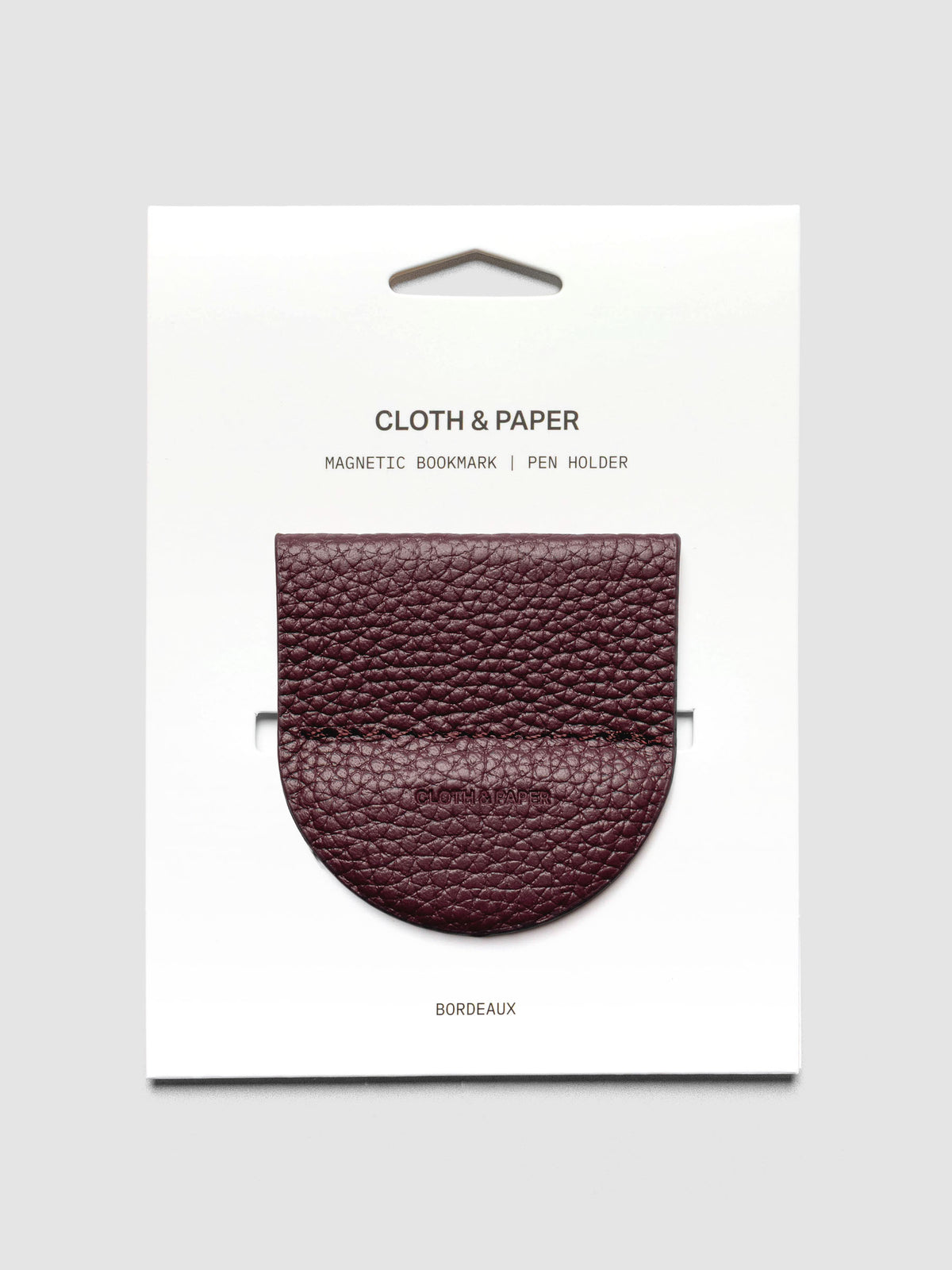 Magnetic Bookmark | Pen Holder in Bordeaux, a deep red, displayed on a white backing card against a neutral background.