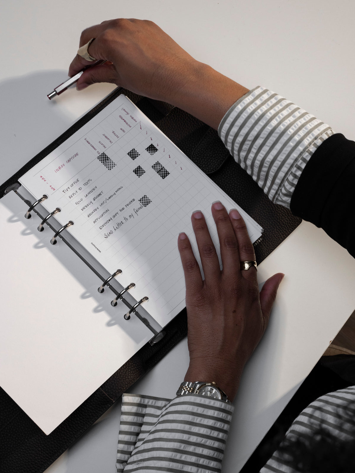 A5 sized Inbox Sorting Planner Inserts shown in use inside a black agenda.