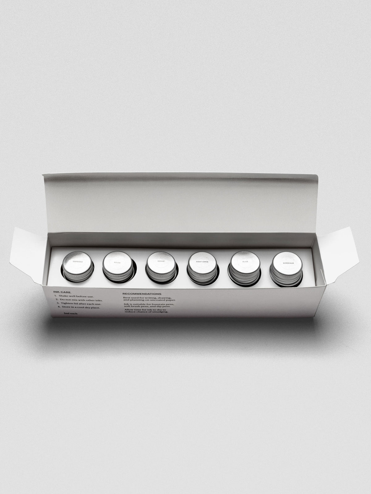 Set of six miniature bottles of fountain pen ink in six unique colors shown in packaging.