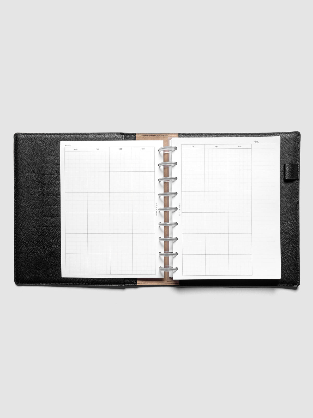 HP Classic Monthly Graph Planner Inserts shown discbound in a black leather folio.