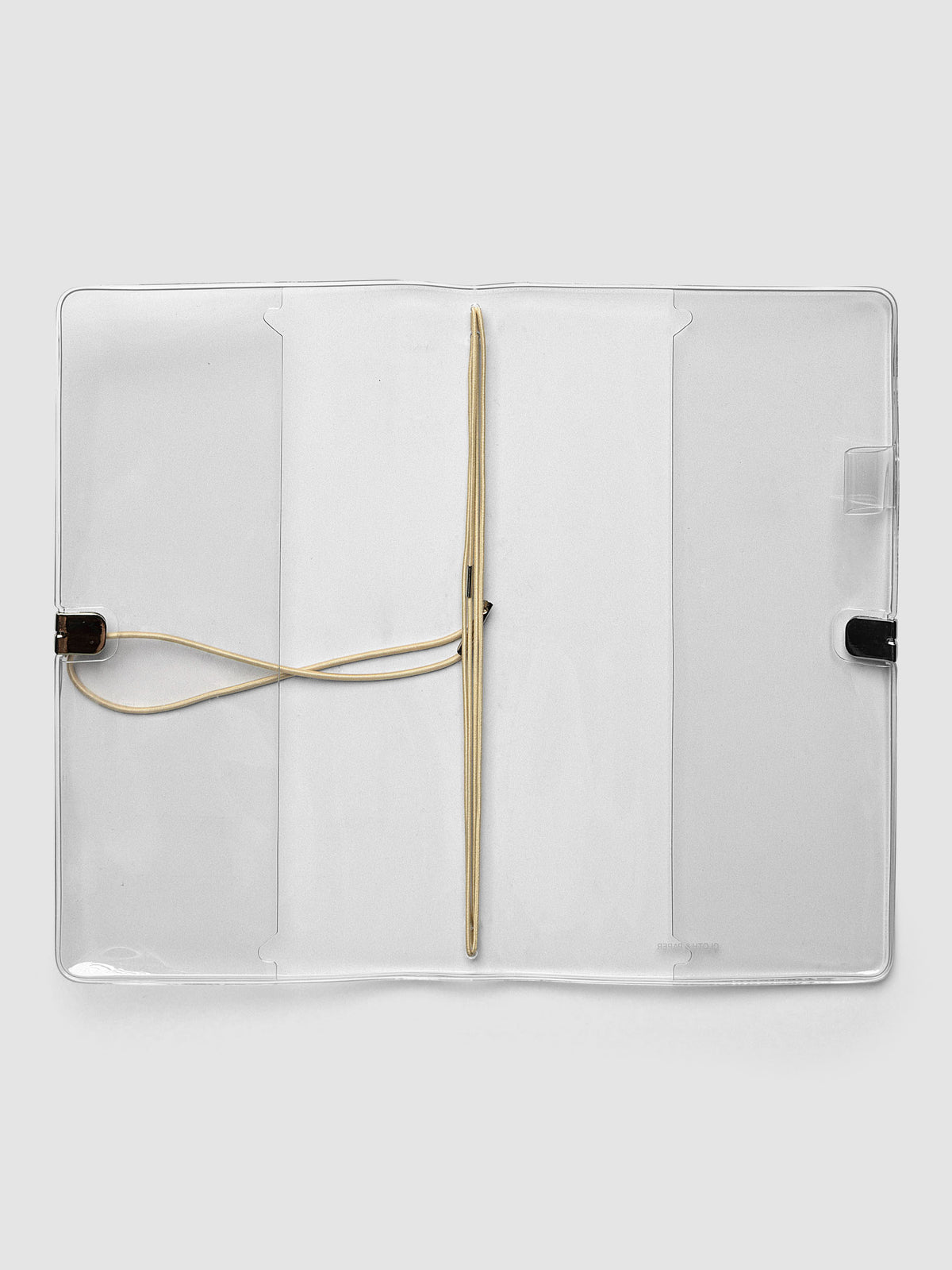 Clear Vinyl Travel Notebook Cover in A5 Slim shown open flat with the interior pockets and bungee strings visible.