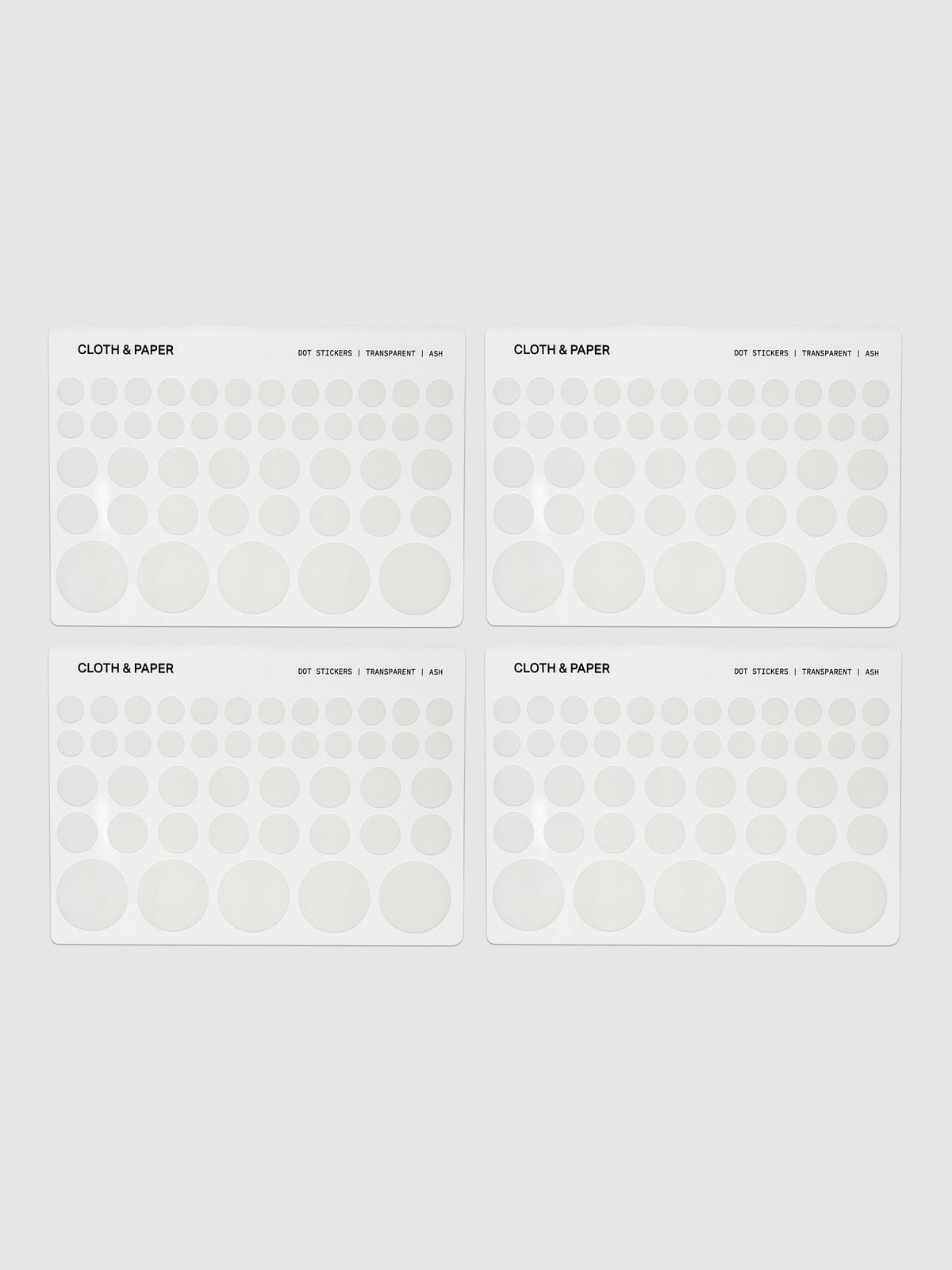 Four sheets of transparent dot stickers with letters design in small, medium, and large sizes shown against a neutral background.