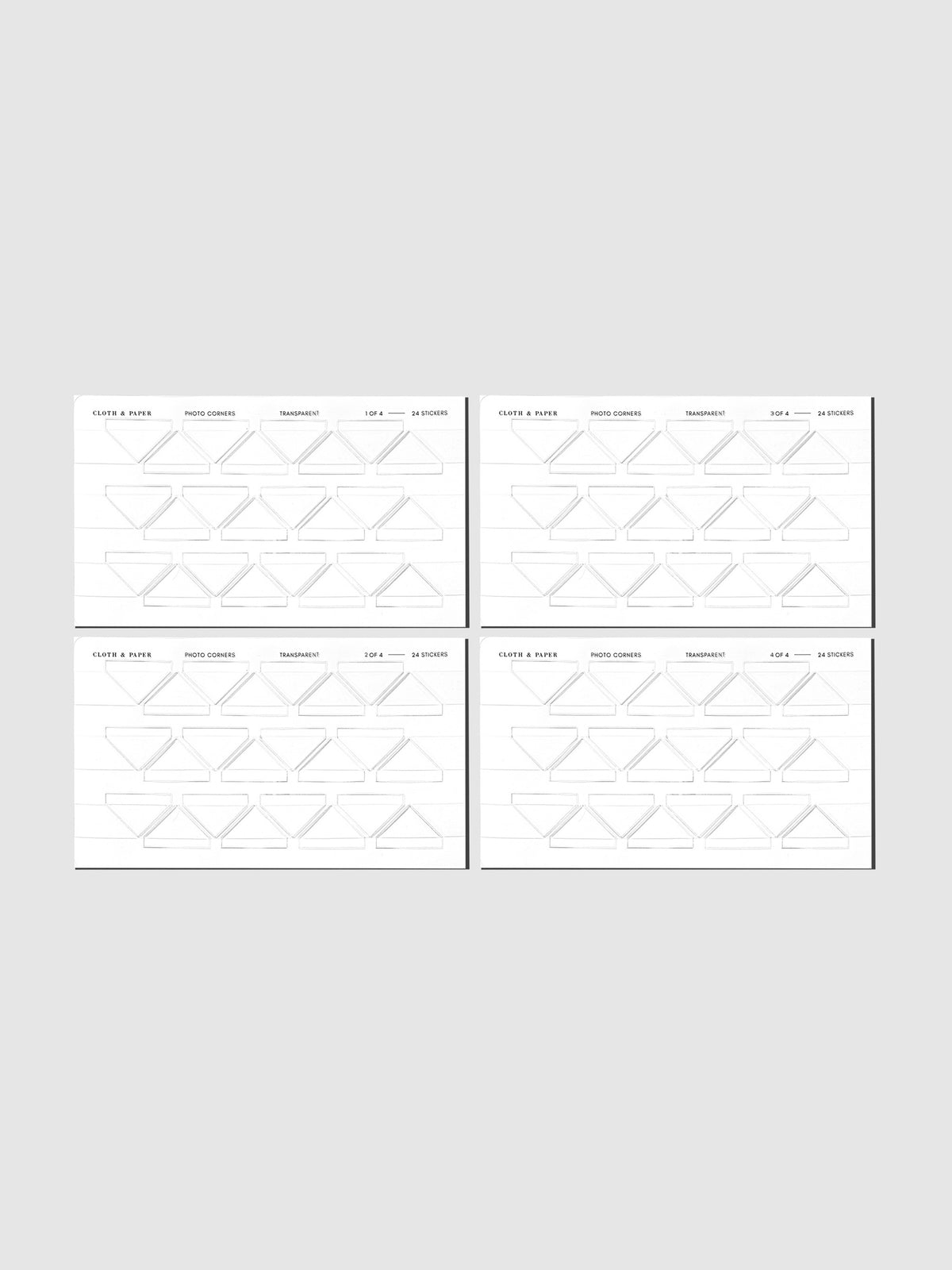 Four clear photo corner sticker sheets displayed in their packaging on a neutral background.