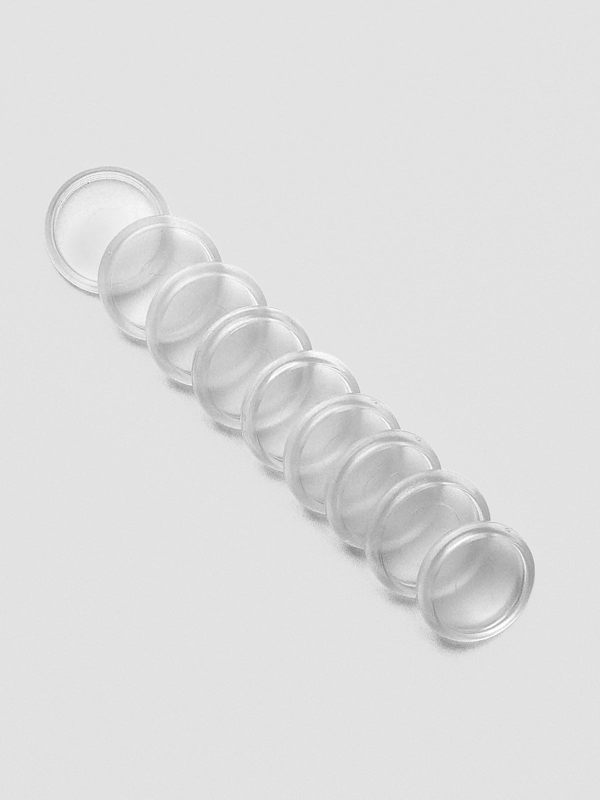 Set of nine Clear 0.75 inch planner discs laid flat on a neutral background.