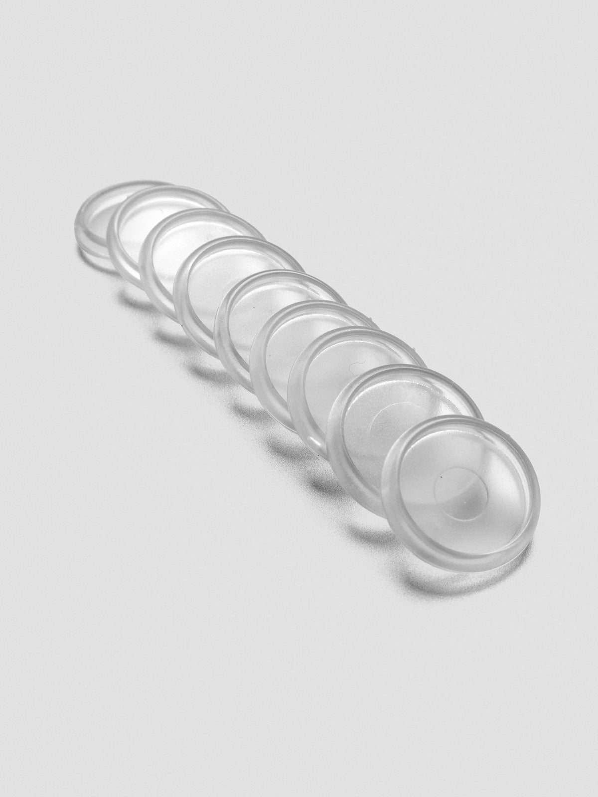 Set of nine Clear 0.75 inch planner discs angled and laid out on a neutral background.