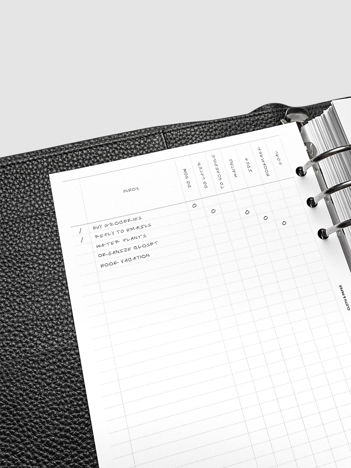 Close up of the demo page for the Inbox Sorting Planner Inserts shown pre-punched for 6-Ring A5 planners in a black agenda.