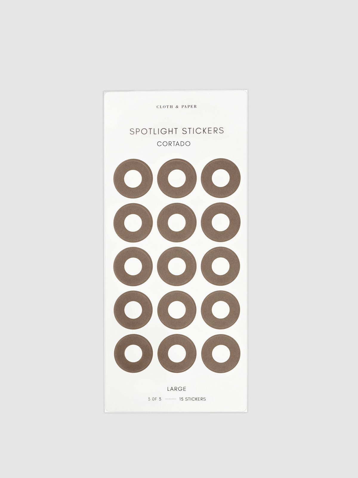 Large sticker in its packaging displayed on a neutral background. Pictured color is cortado.