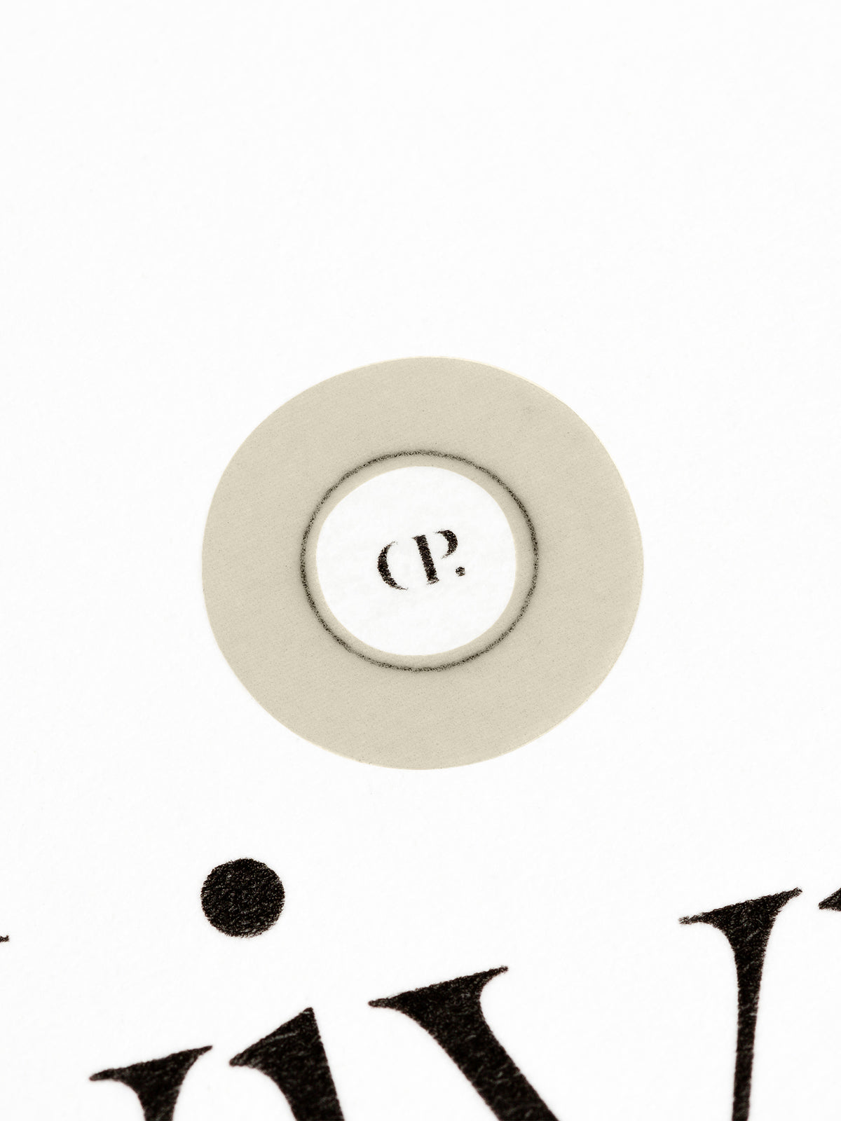 Small sticker in use, placed over the Cloth and Paper logo on a sheet of paper.