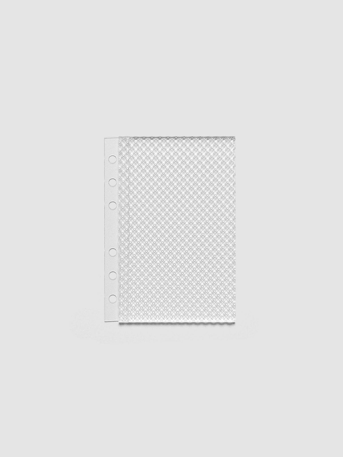 Clear, textured Studded Planner Dashboard in the size A6, on a neutral background.
