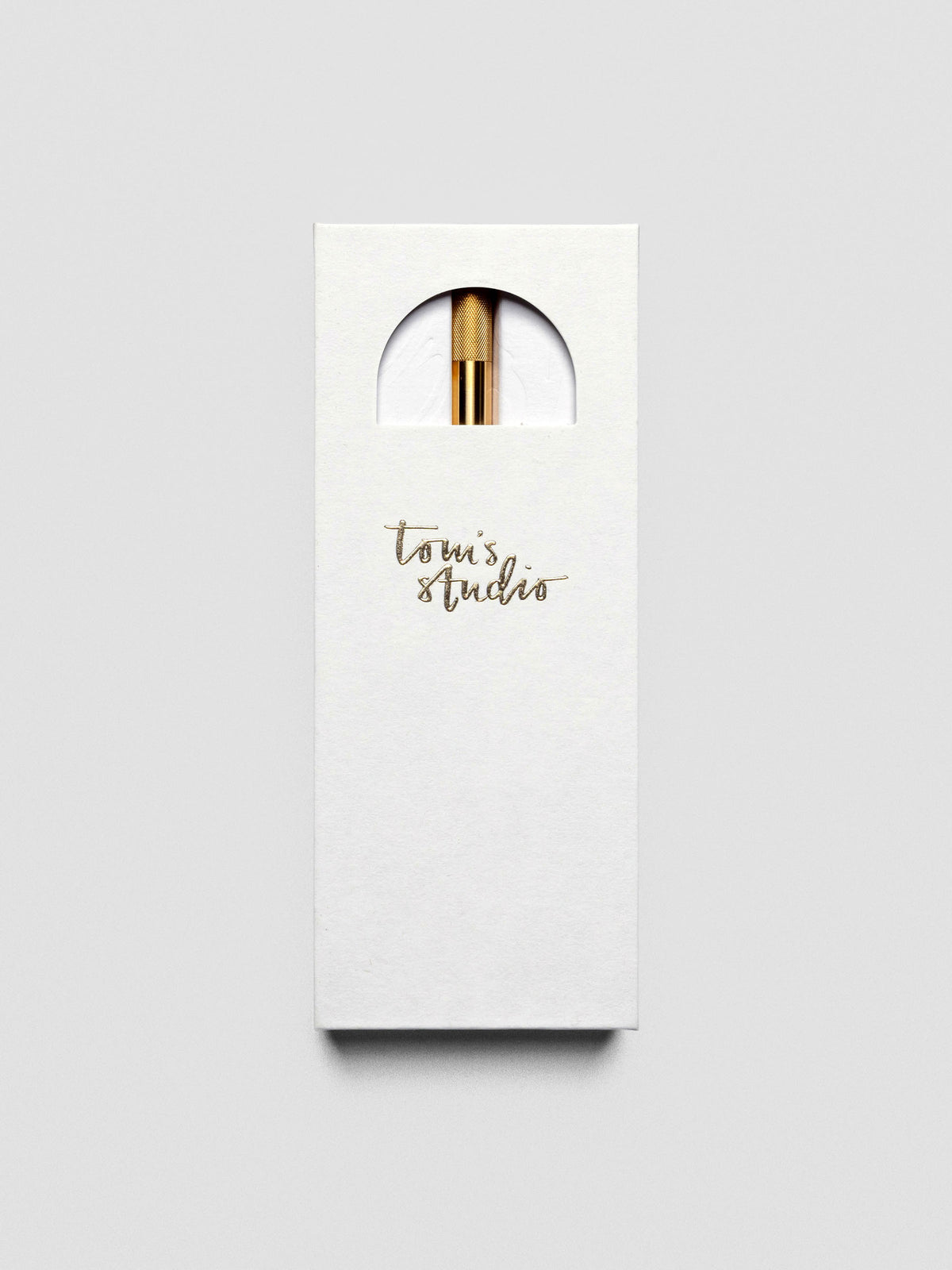 Lumos Pro Single Tip Pen in Brass, shown in packaging.