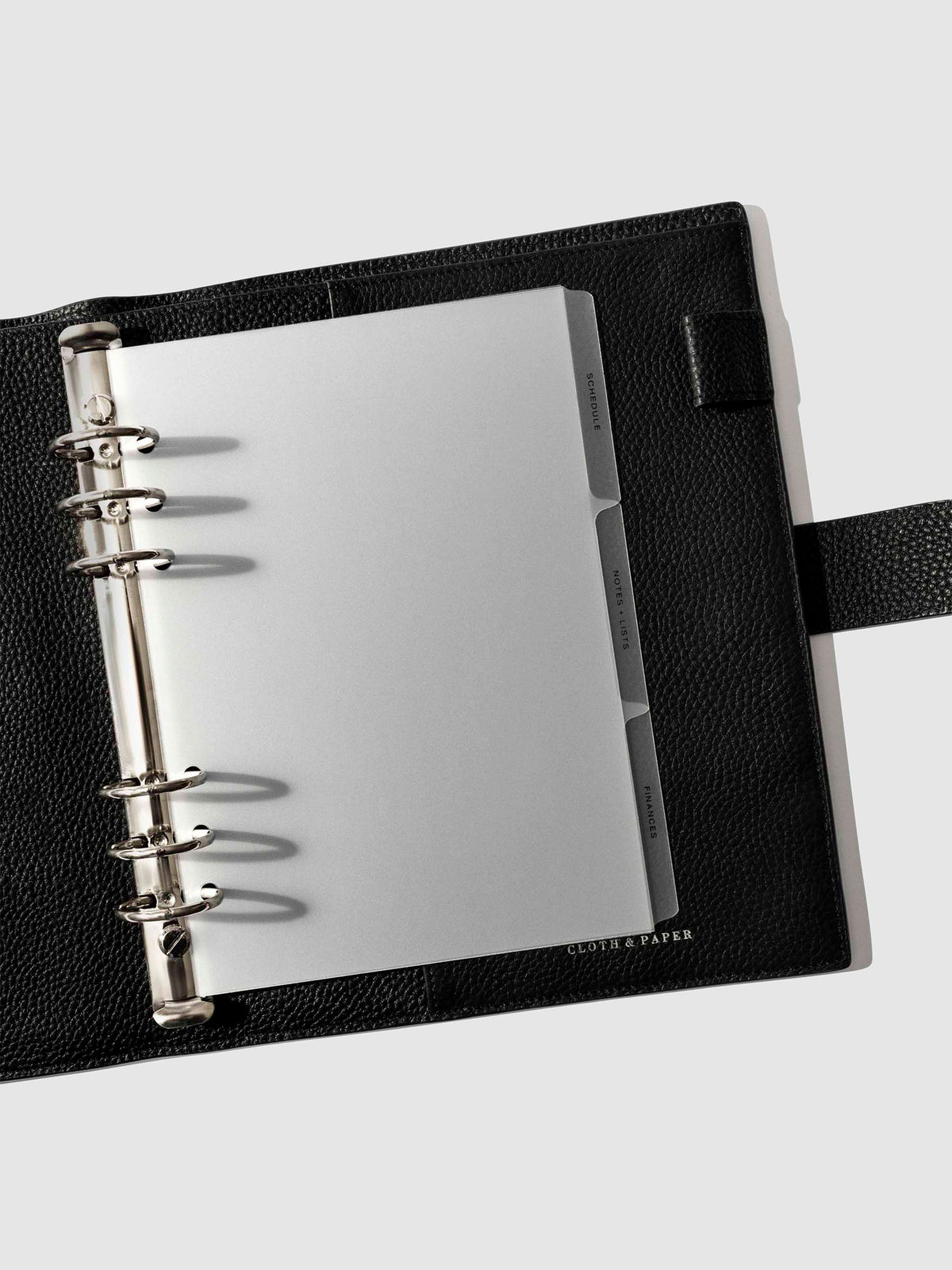 Black foil tabs displayed in use inside a leather folio.