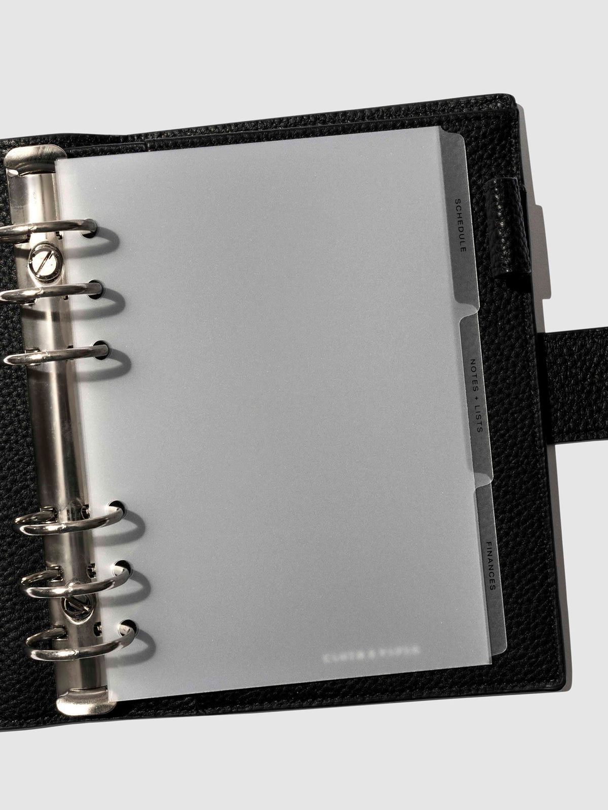 Black foil tabs displayed in use inside a leather folio.