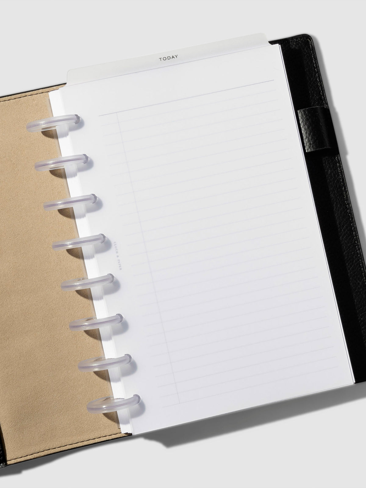 Black foil divider displayed in a black leather planner.
