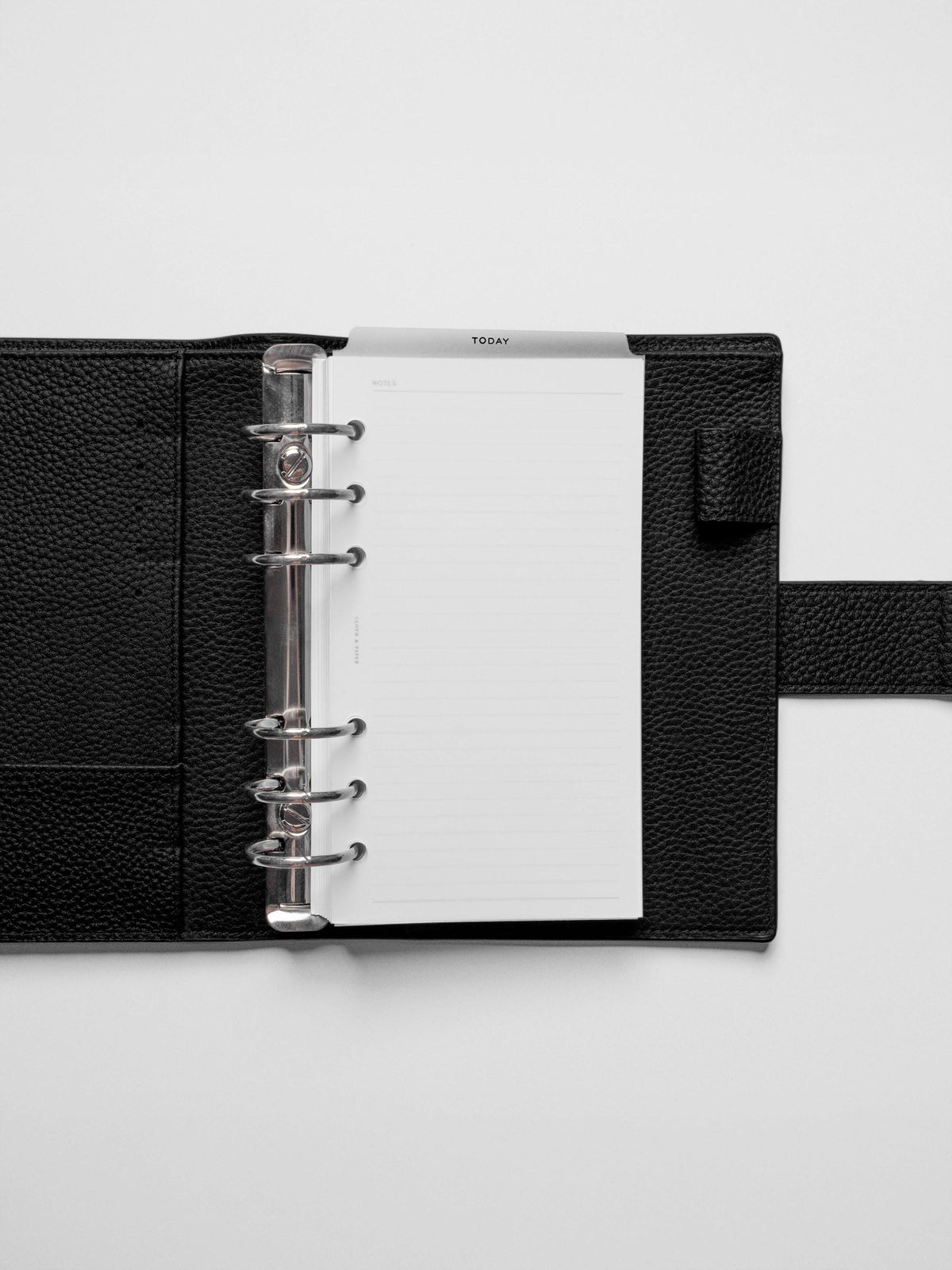 Black foil divider displayed in a black leather planner.