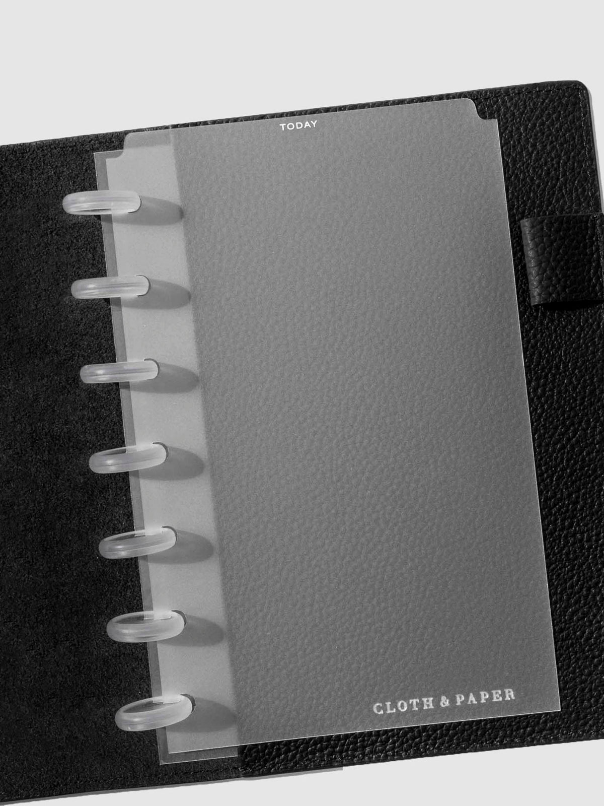 Divider in use inside a black leather planner.