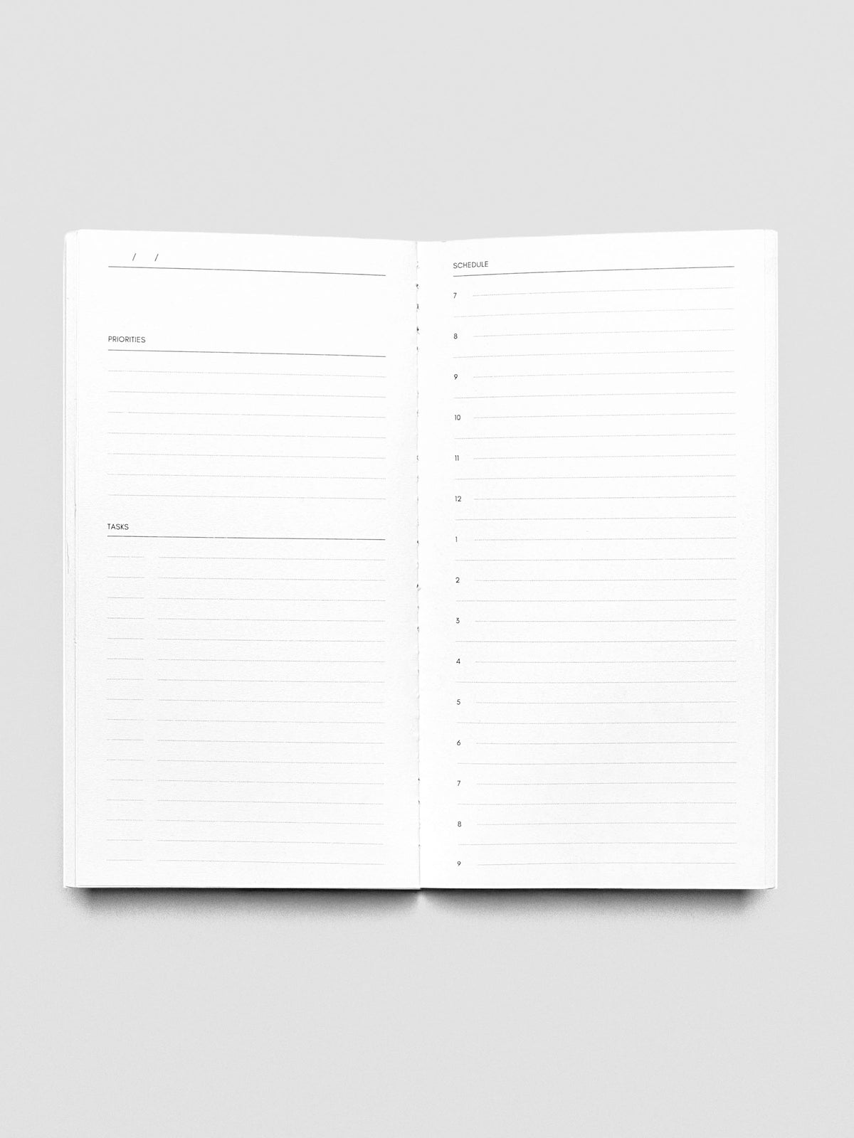 Pocket Plus Travel Notebook shown open displaying the Undated Daily pages.