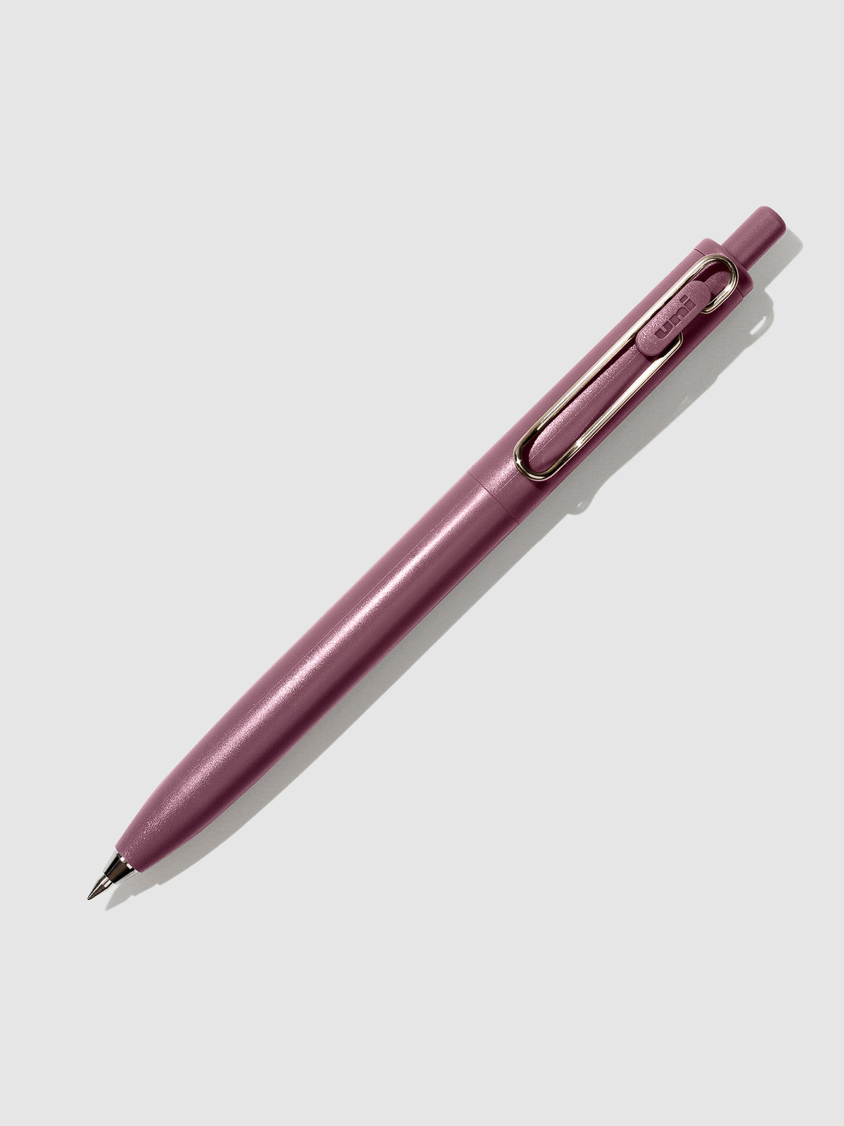 Cherry pen turned to the right against a neutral background.
