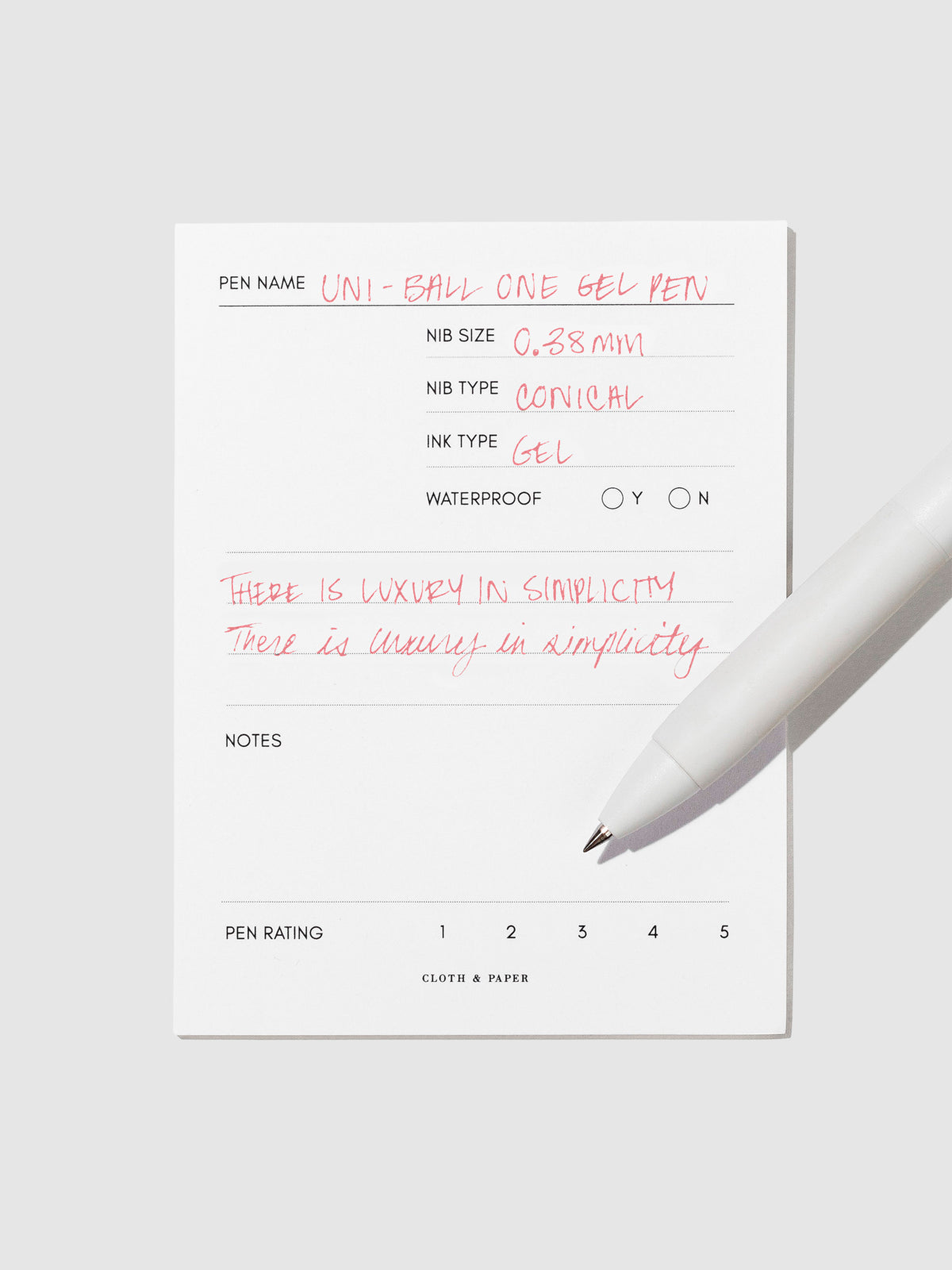 Pen tilted slightly to the right on a neutral background. Color pictured is Poppy Red.