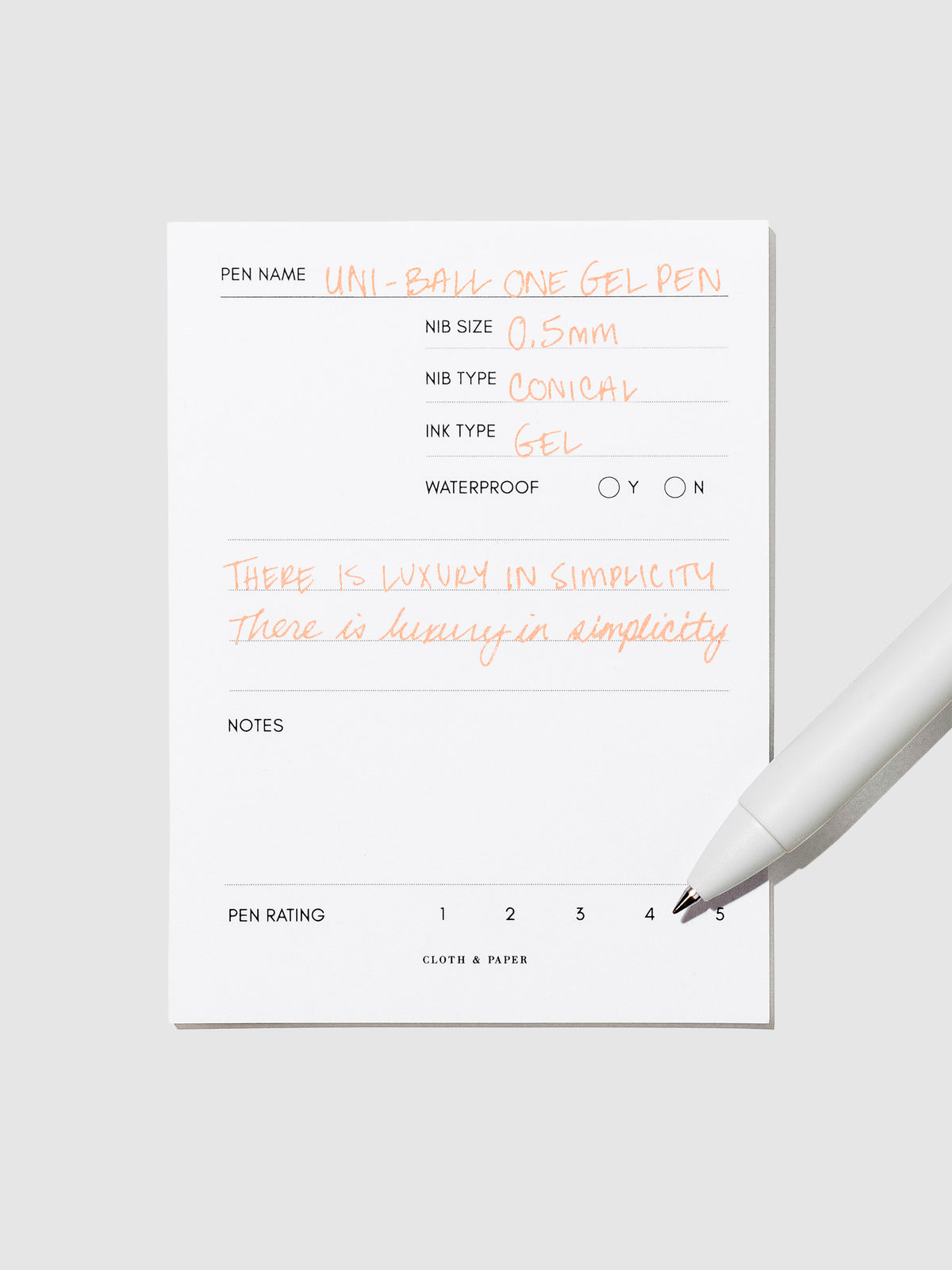 Pen tilted slightly to the right on a neutral background. Color pictured is Mango Orange.