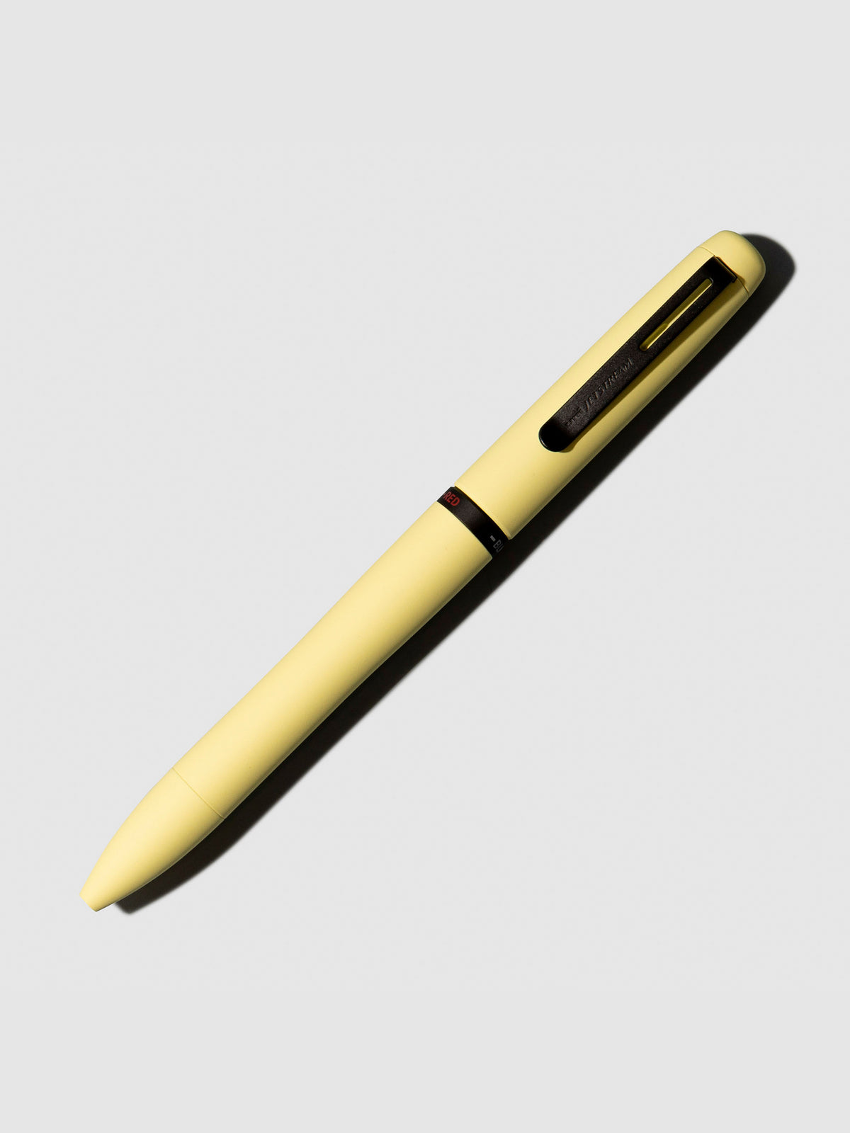 Uni Jetsream Prime Light Touch Gel Pen, Cloth and Paper. Pen shown on a neutral background with its tip retracted. Color shown is Citron Yellow.