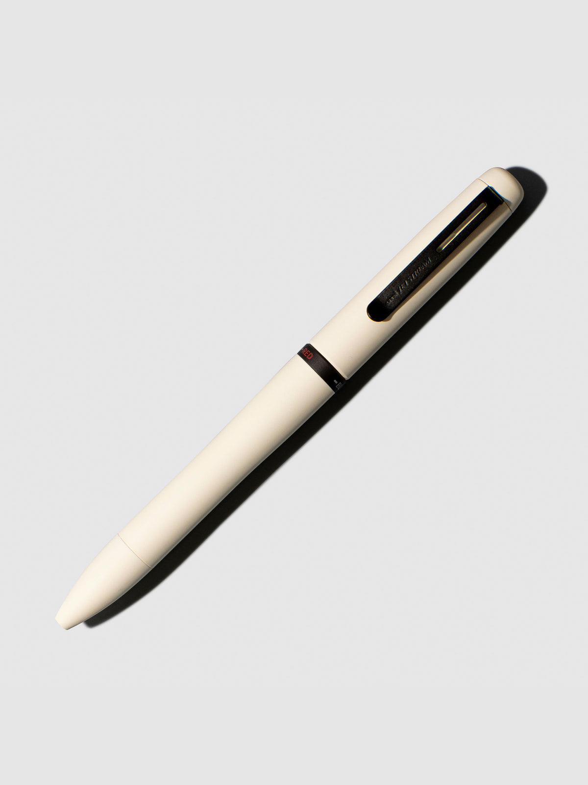Uni Jetsream Prime Light Touch Gel Pen, Cloth and Paper. Pen shown on a neutral background with its tip retracted. Color shown is Cloudy White.