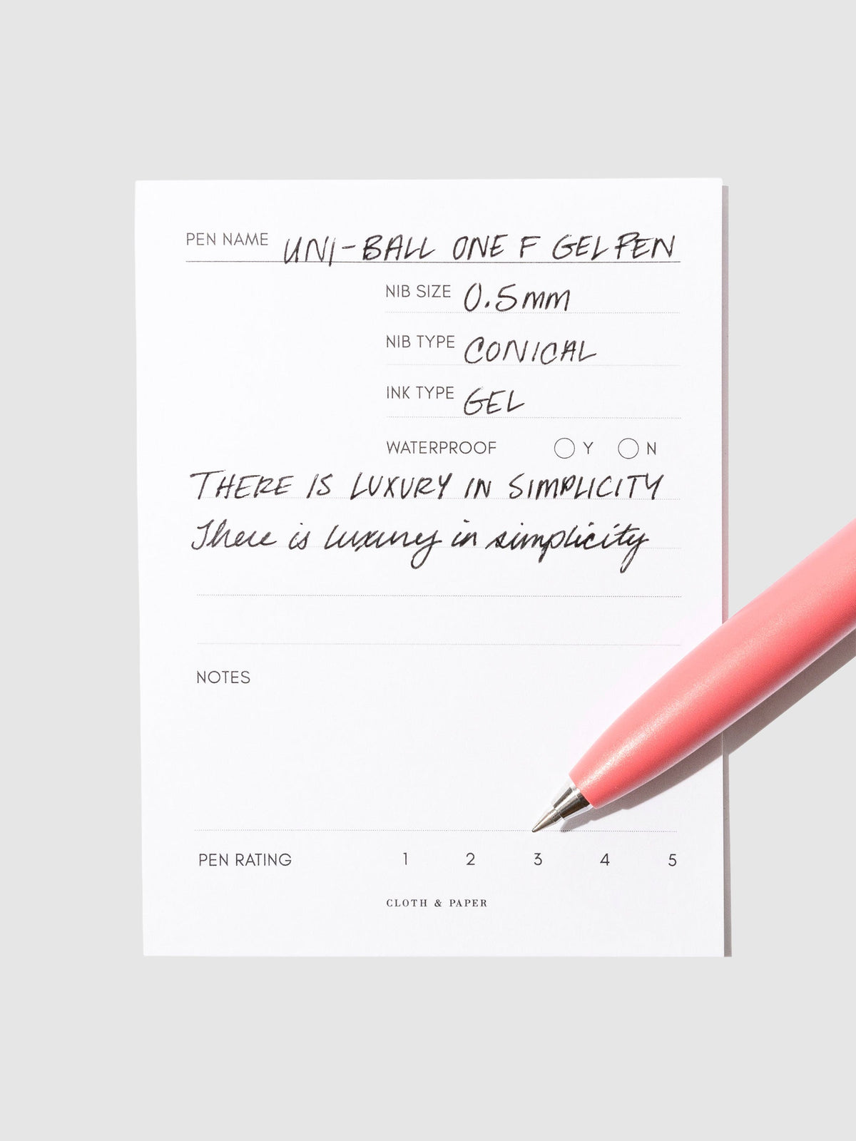 Red pen resting on an in use pen test sheet.