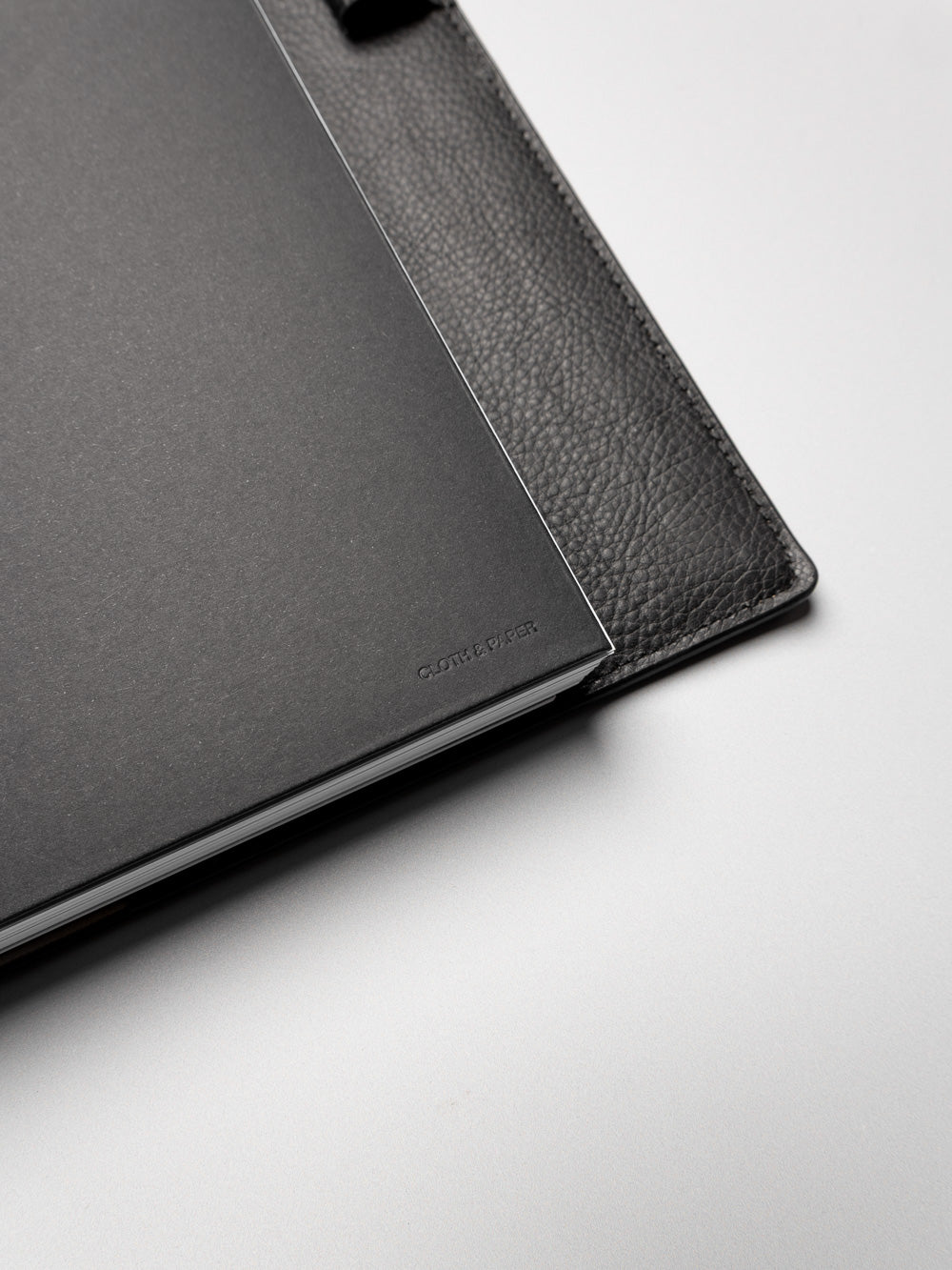 Detail view of the black planner paper pocket folder shown in size Half Letter 8-Disc Punch