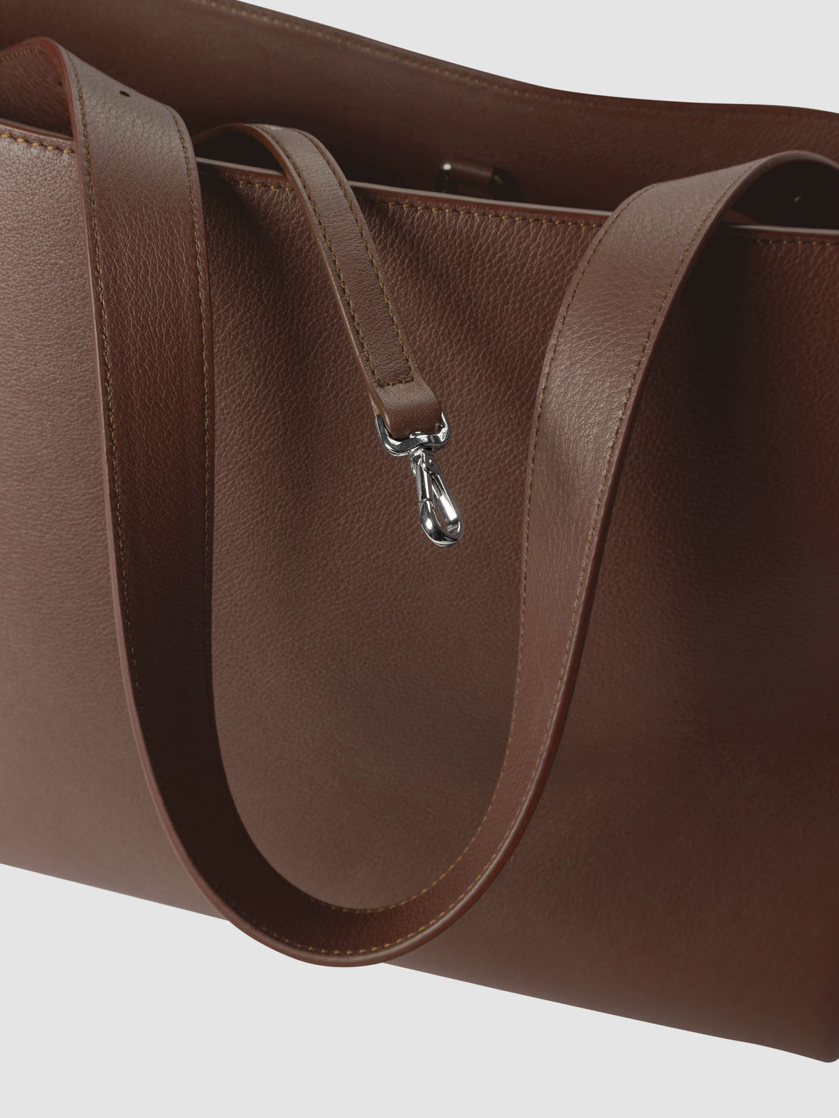 Detail view of the key leash on The Metro Tote in the color Cordoba.