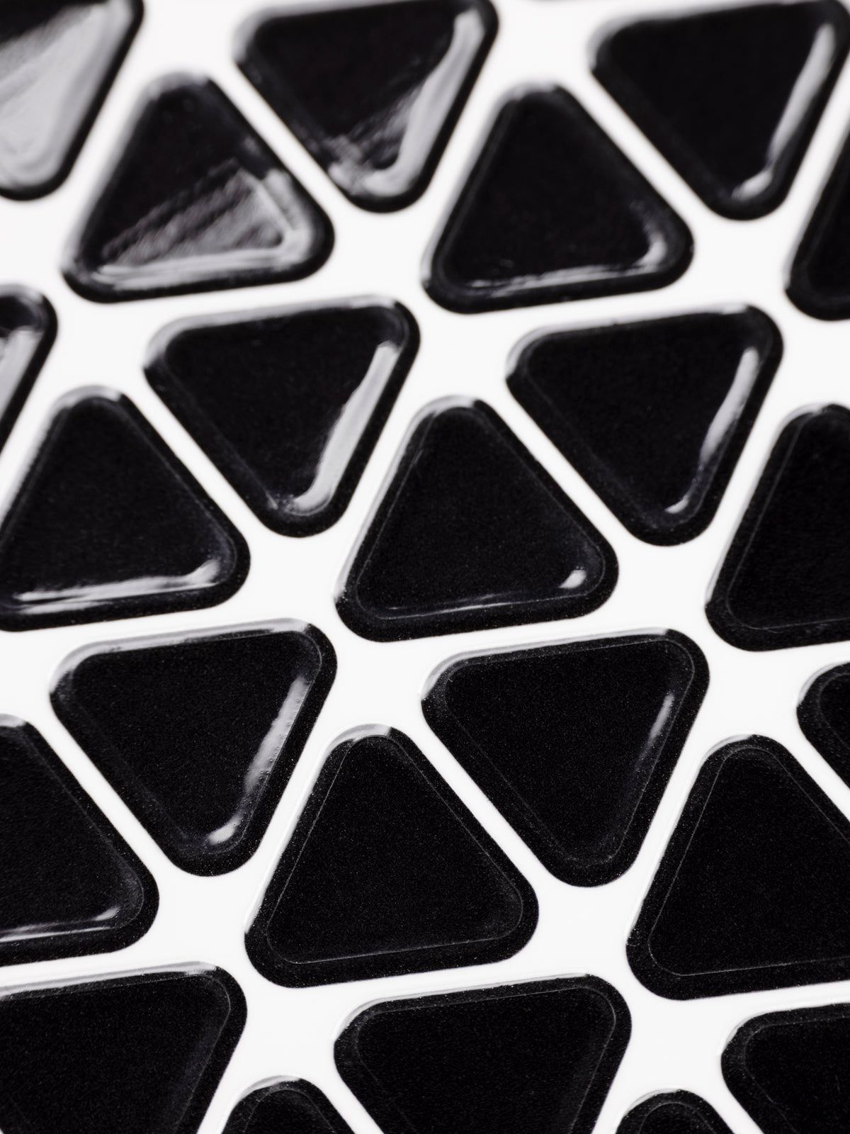 Close up of a sheet of high gloss, black triangle planner stickers